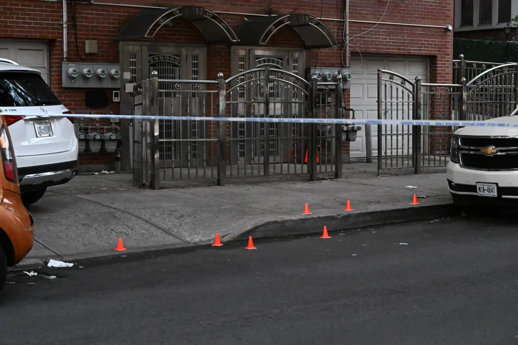 Crime scene tape and orange cones mark a residential area on Grand Avenue in the Bronx where a man was fatally shot.