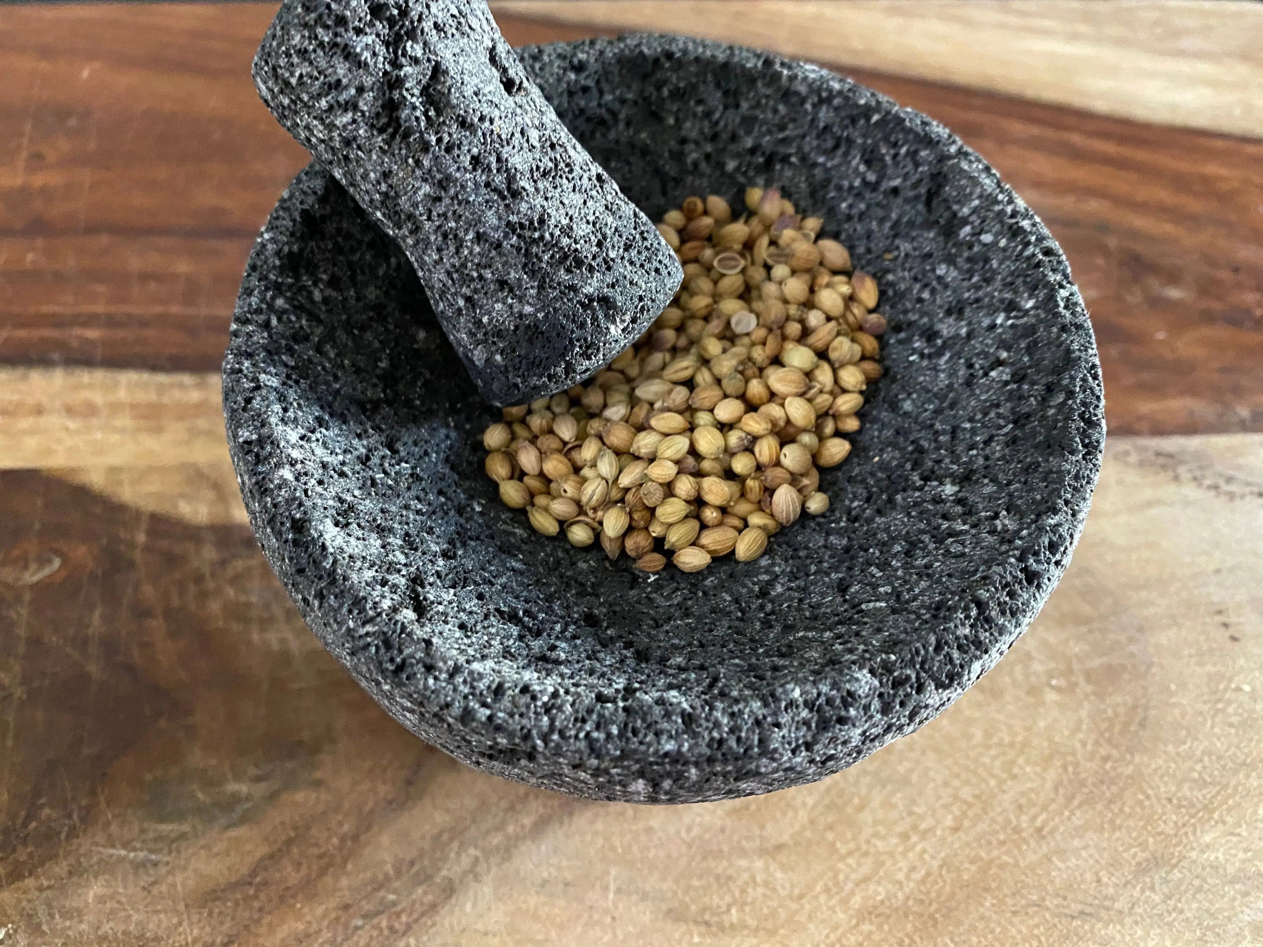 coriander seeds in mortar and pestle