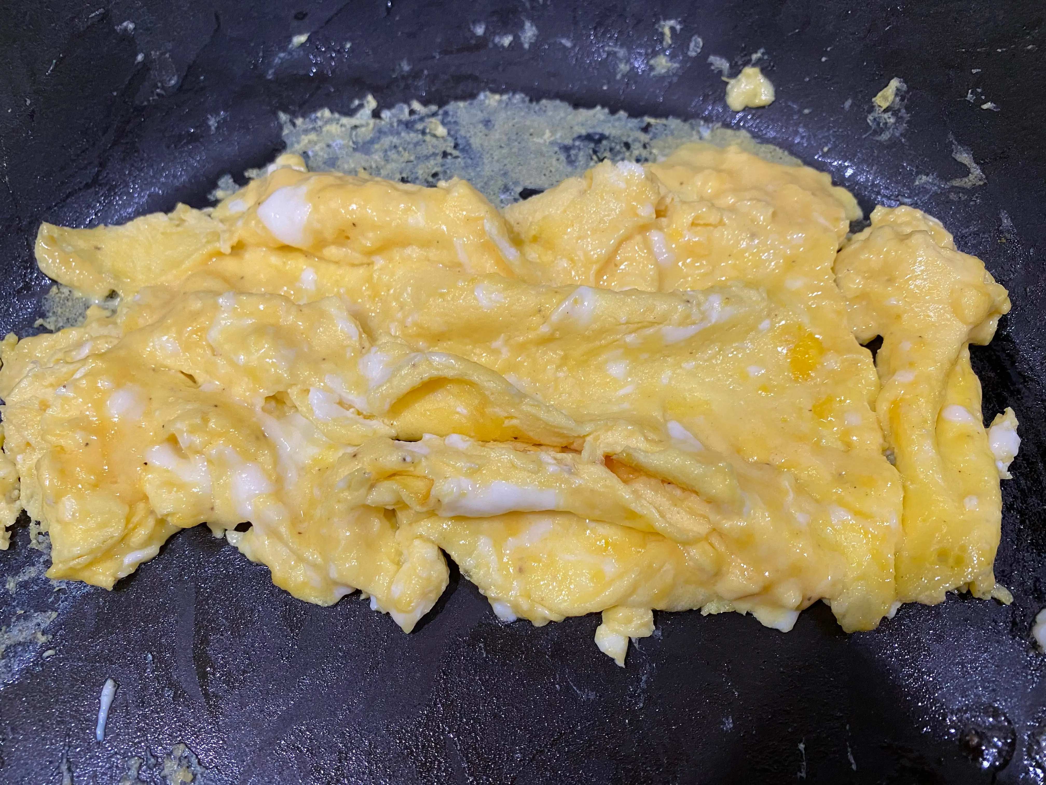 folded eggs in pan