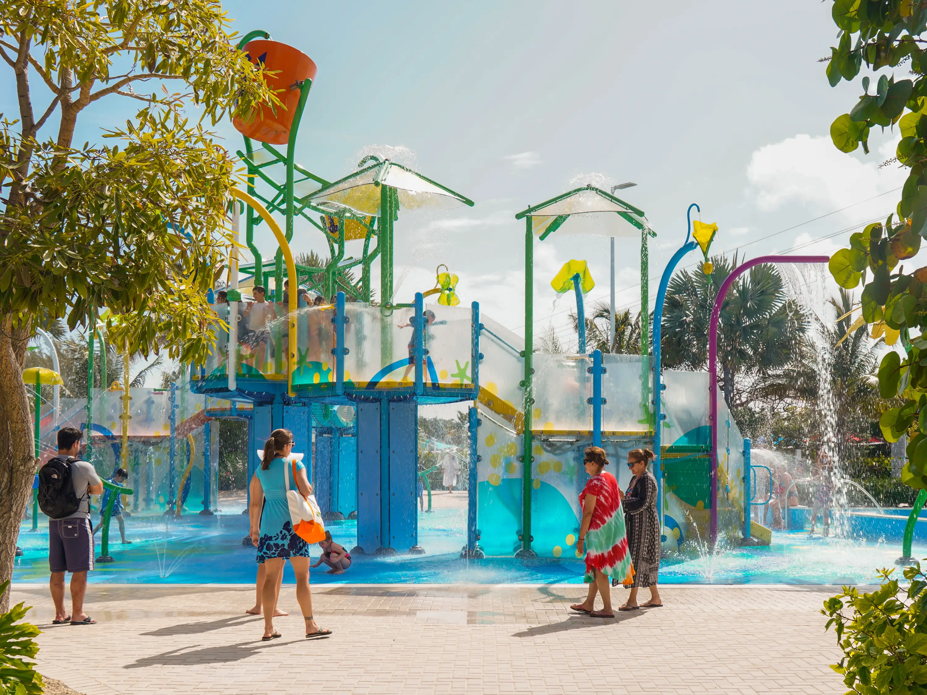 People walk around Splashaway bay at CocoCay on a partly cloudy day