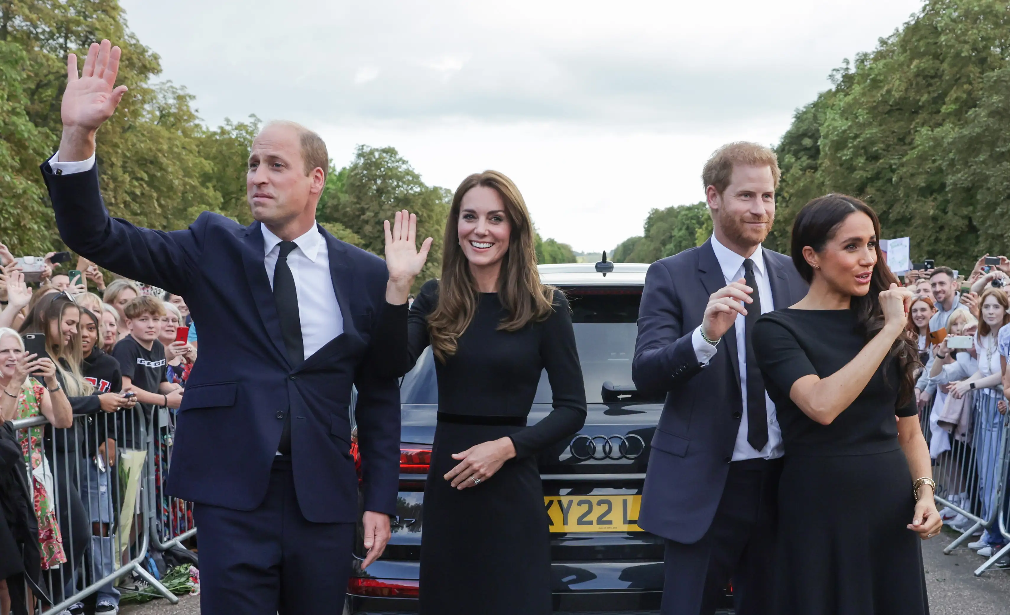 Prince William, Princess Kate, Prince Harry, and Meghan Markle wave as they walk around Windsor Castle