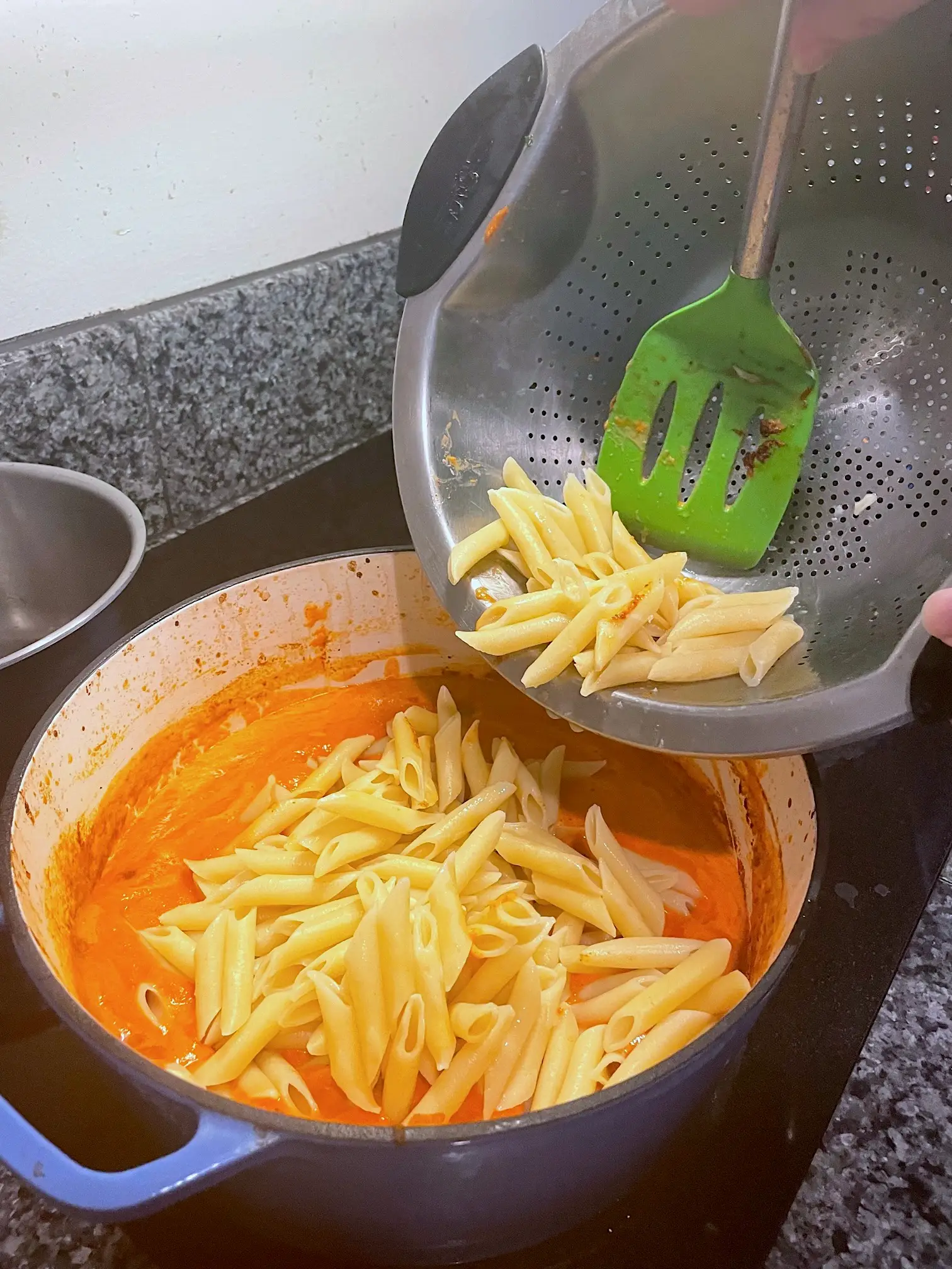 Adding the pasta to sauce for Ina Garten's Penne Alla Vodka