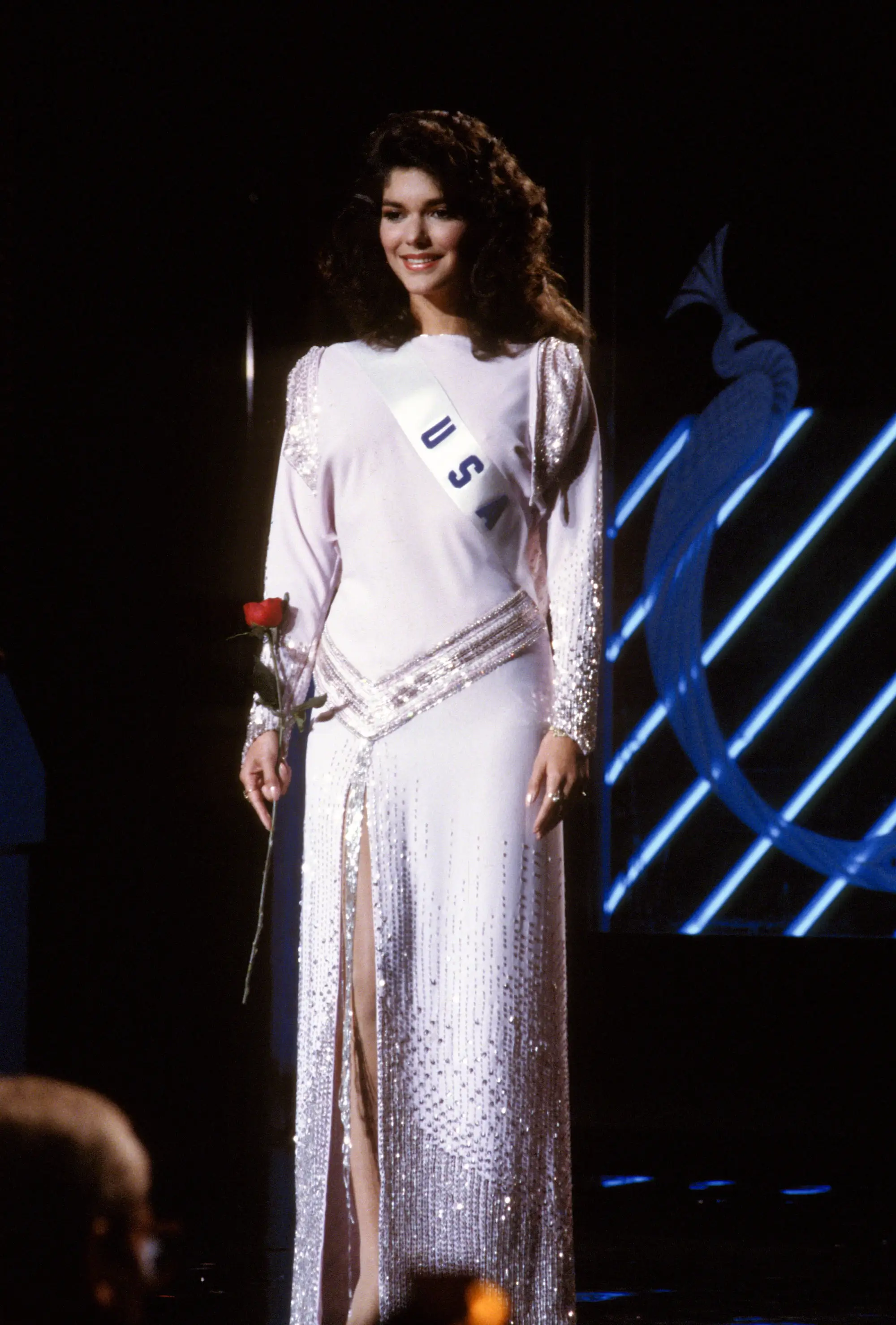 Miss USA 1985 Laura Harring poses in an evening gown and her sash.