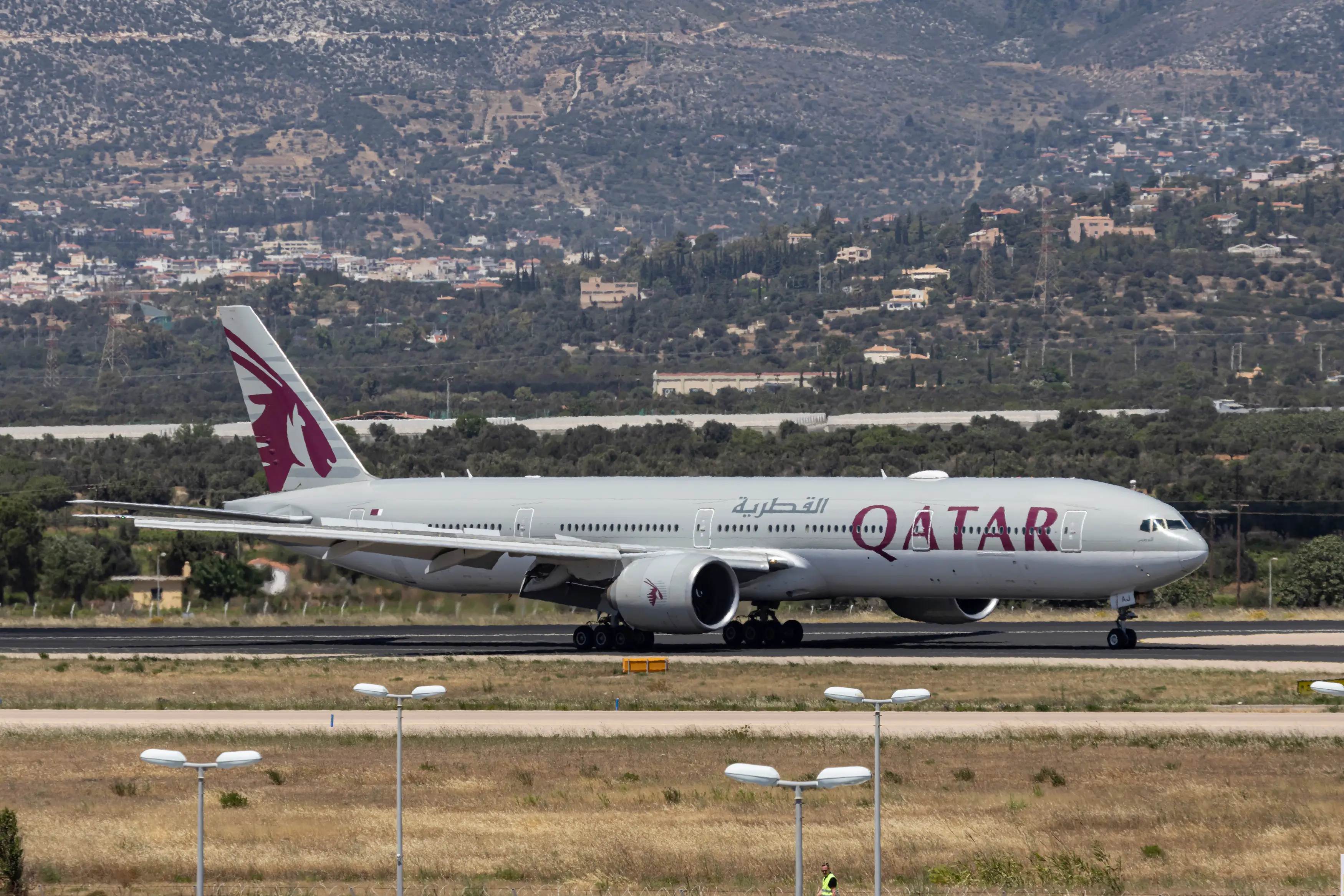 A Qatar Airways plane at an airport.