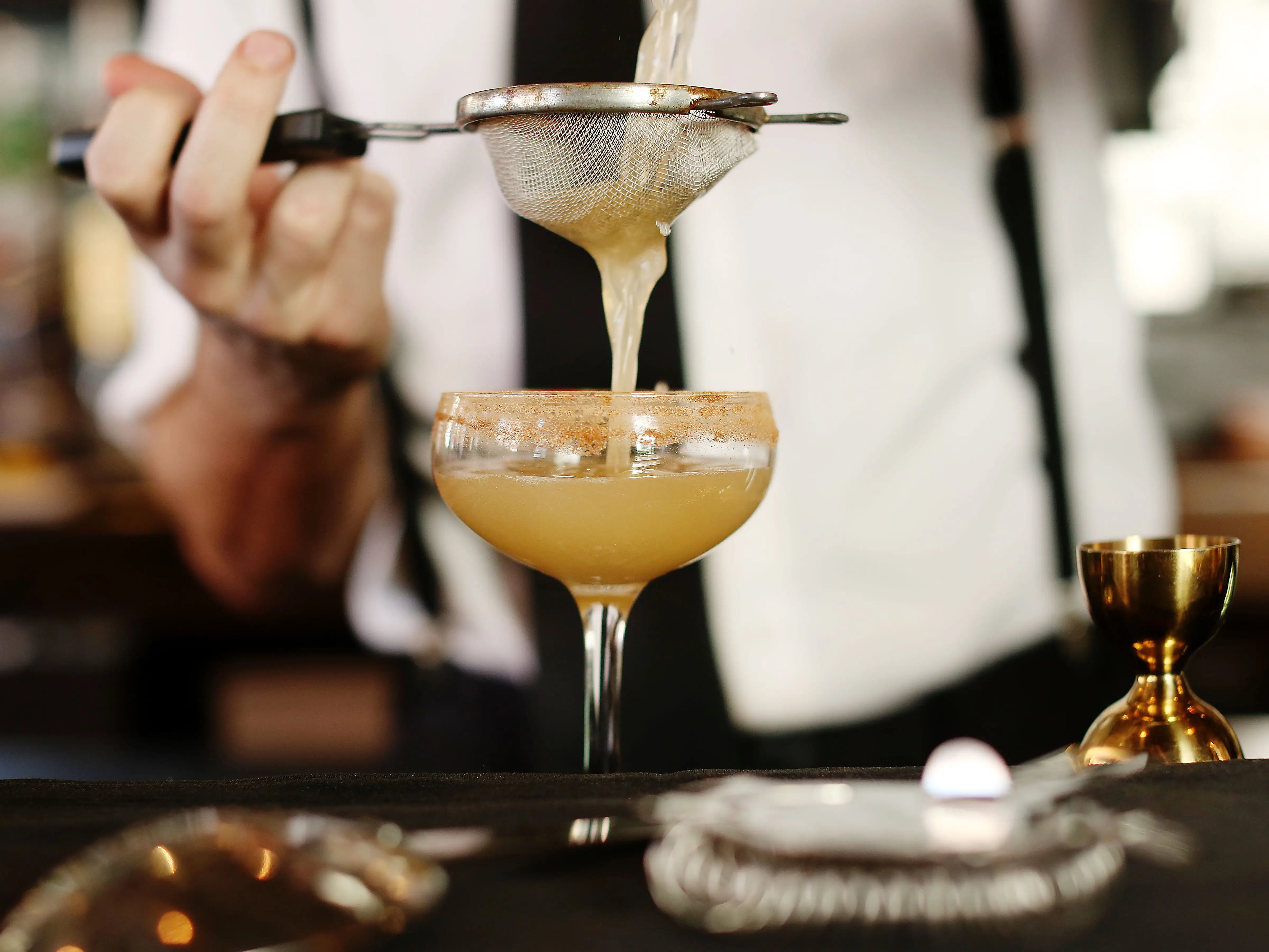 bartender mixing a cocktail at a bar