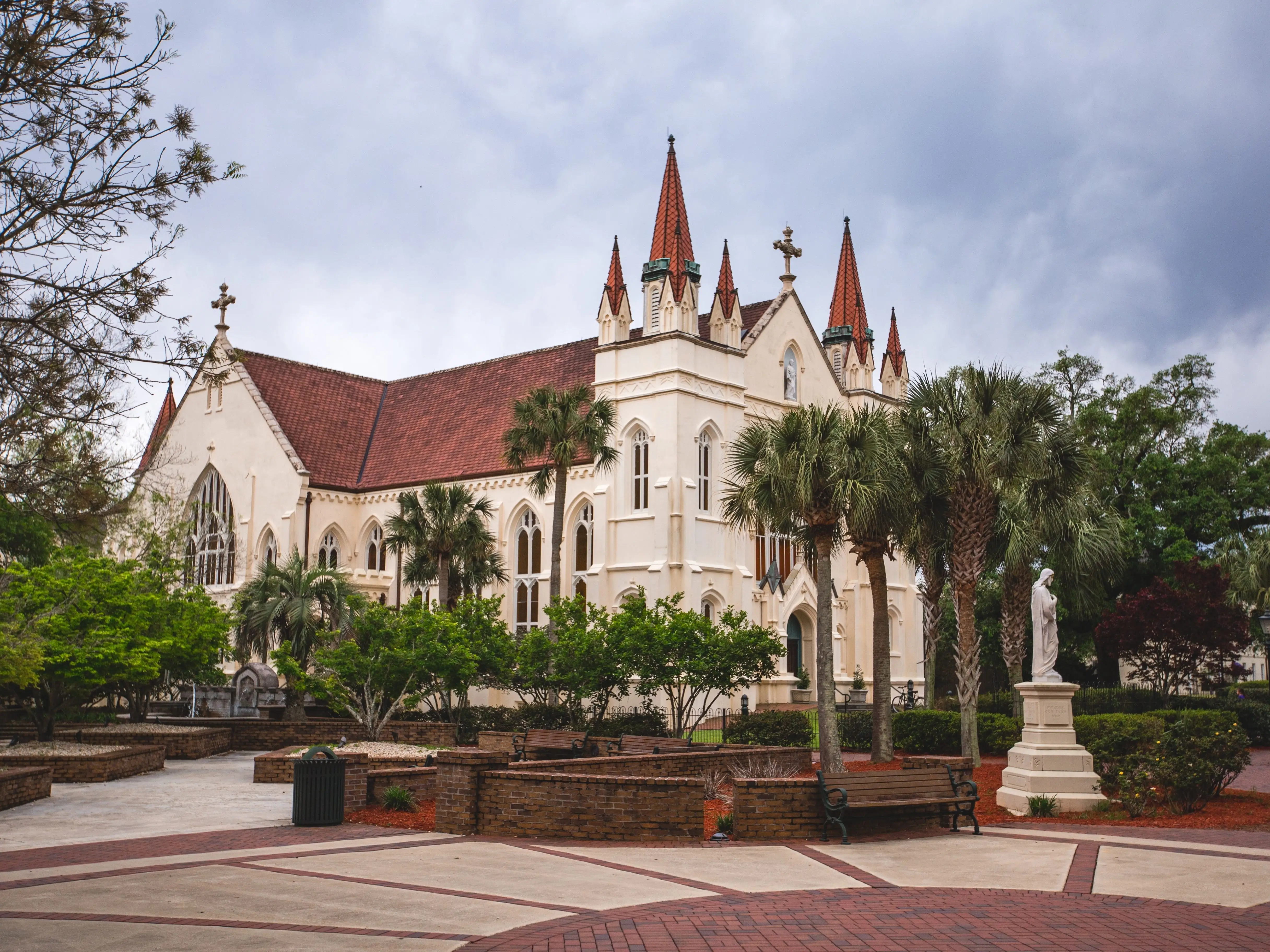 St. Joseph's Chapel in Mobile is surrounded by green palm trees.