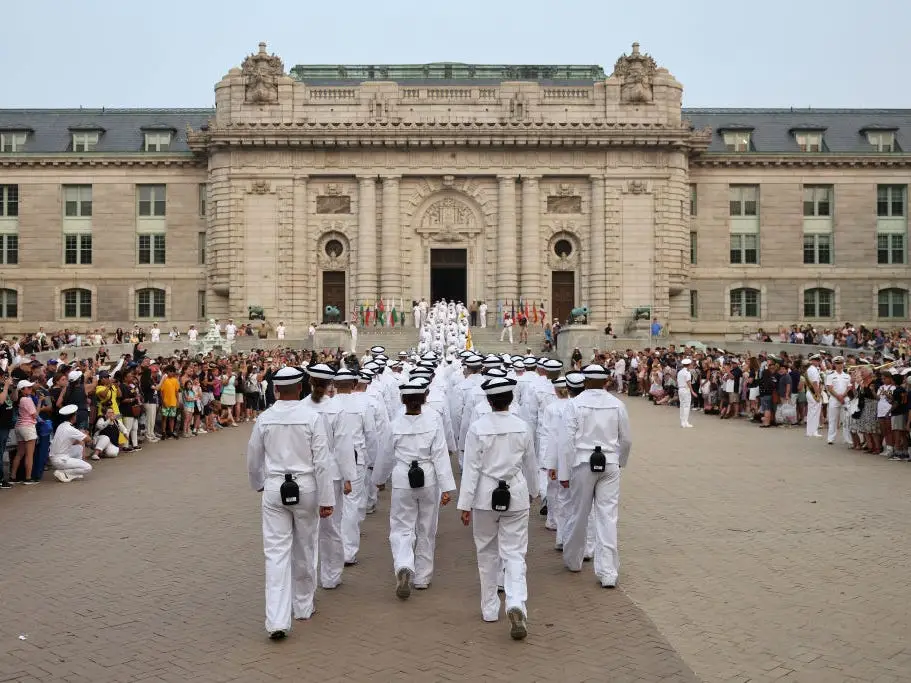 Incoming first-year students march into Bancroft Hall on June 29, 2023, after participating in their oath of office ceremony during the US Naval Academy induction day.