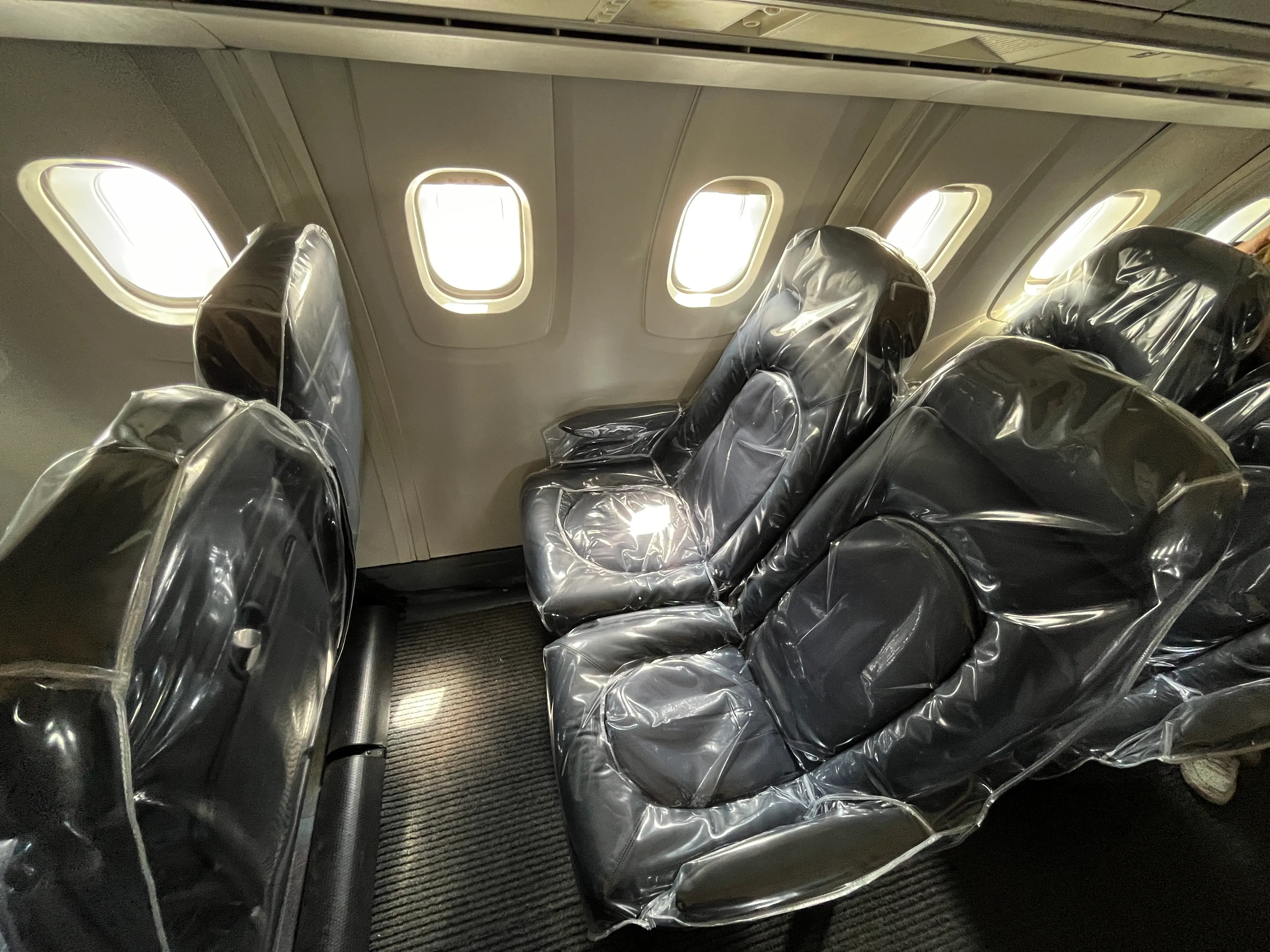 Plastic-covered seats on a plane.
