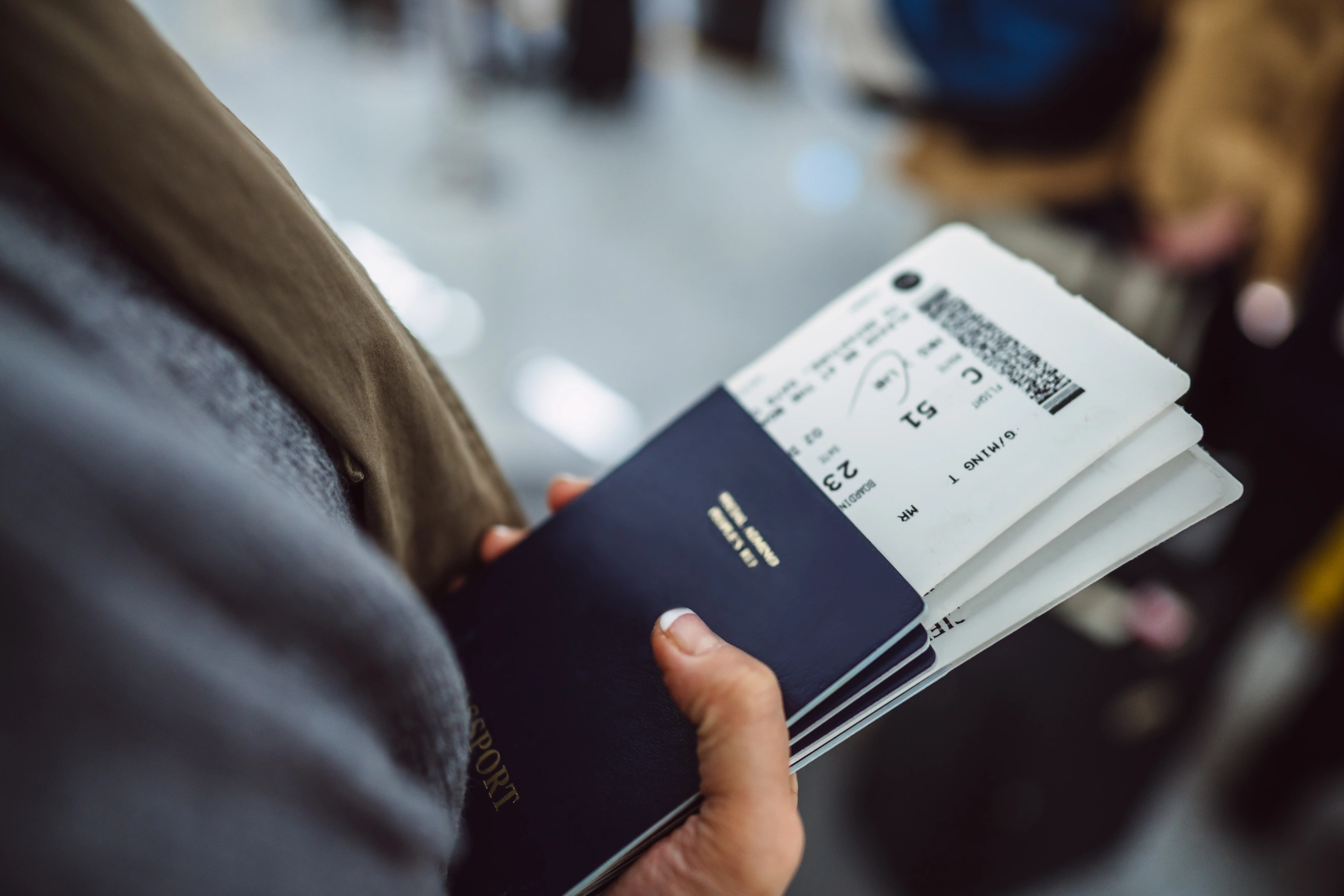 A woman holds passports and boarding passes
