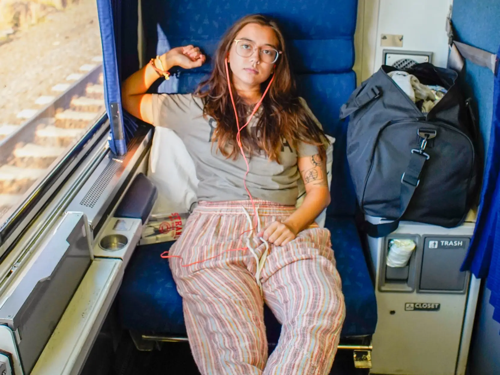 The author sits on the train with her feet up