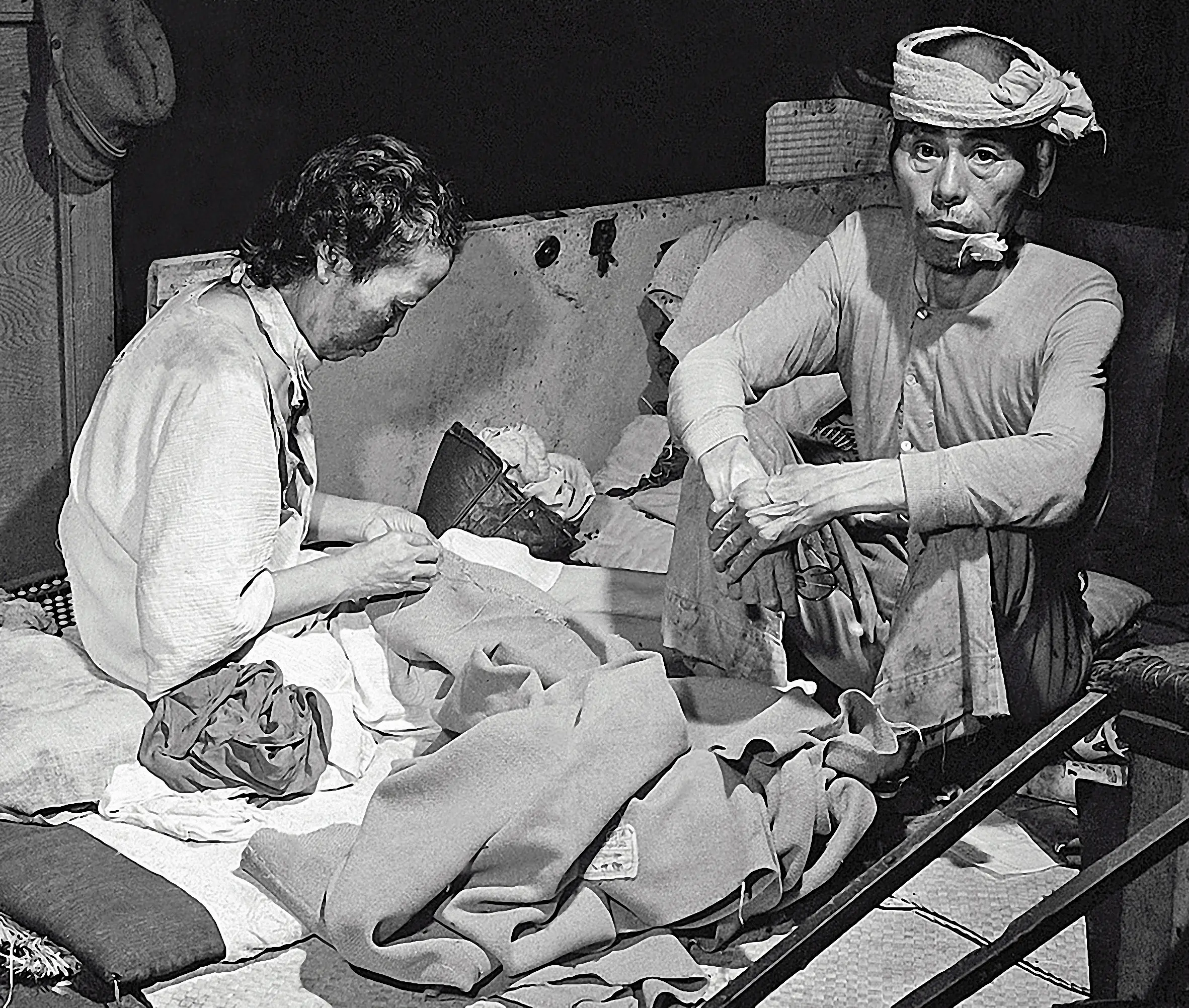 Two victims of the atomic bombing sit in a converted hospital in September 1945.