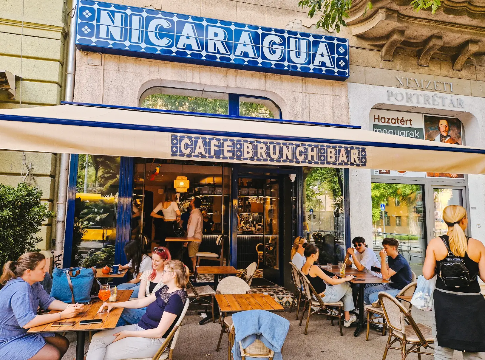 People sitting outside a café called Nicaragua.