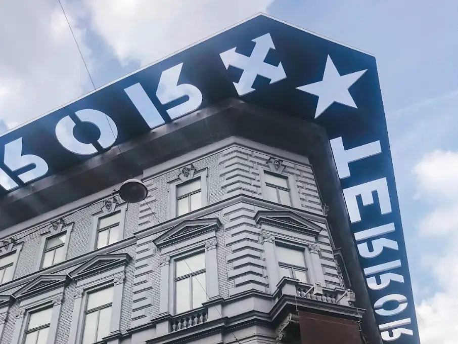 The facade of the House of Terror Museum in Budapest, with black framing around the top of the building.