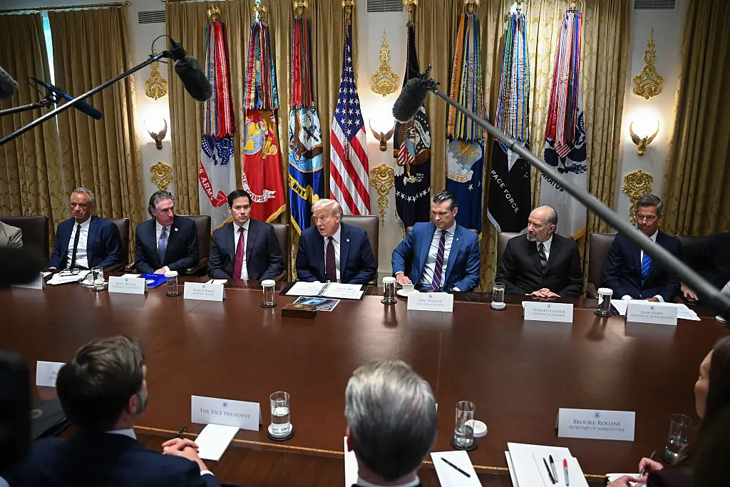 The Cabinet Room decorated with gold furnishings on the walls.