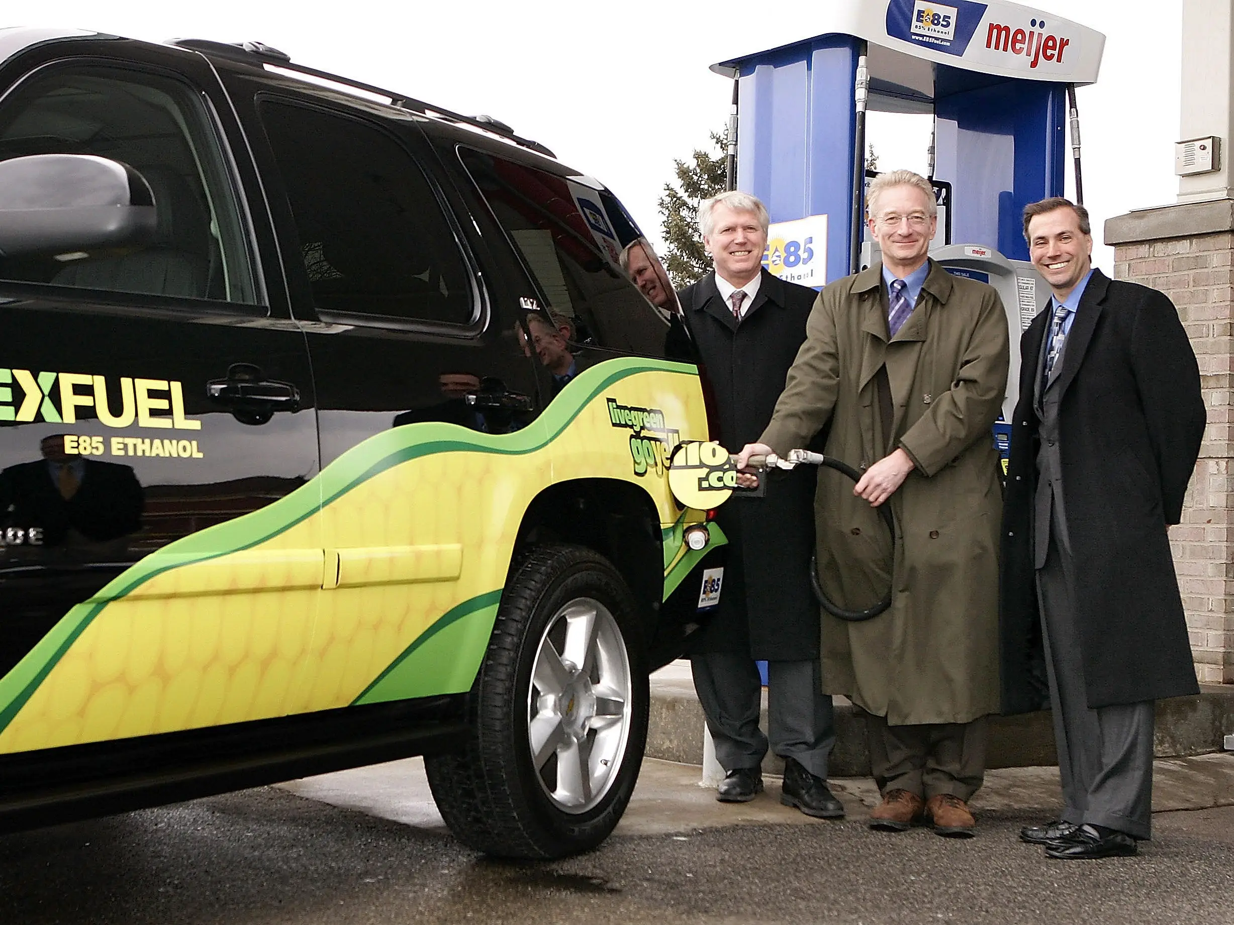 In this handout provided by General Motors, Michigan Department of Agriculture Director Mitch Irwin (L) and General Motors Vehicle Emissions Issues Director Bob Babik (R) look on as Meijer CEO Hank Meijer tests the latest E85 ethanol pump installation at the Meijer station on Ford Road during a press conference announcing the opening of the 20th Meijer's E85 fueling location in the state of Michigan
