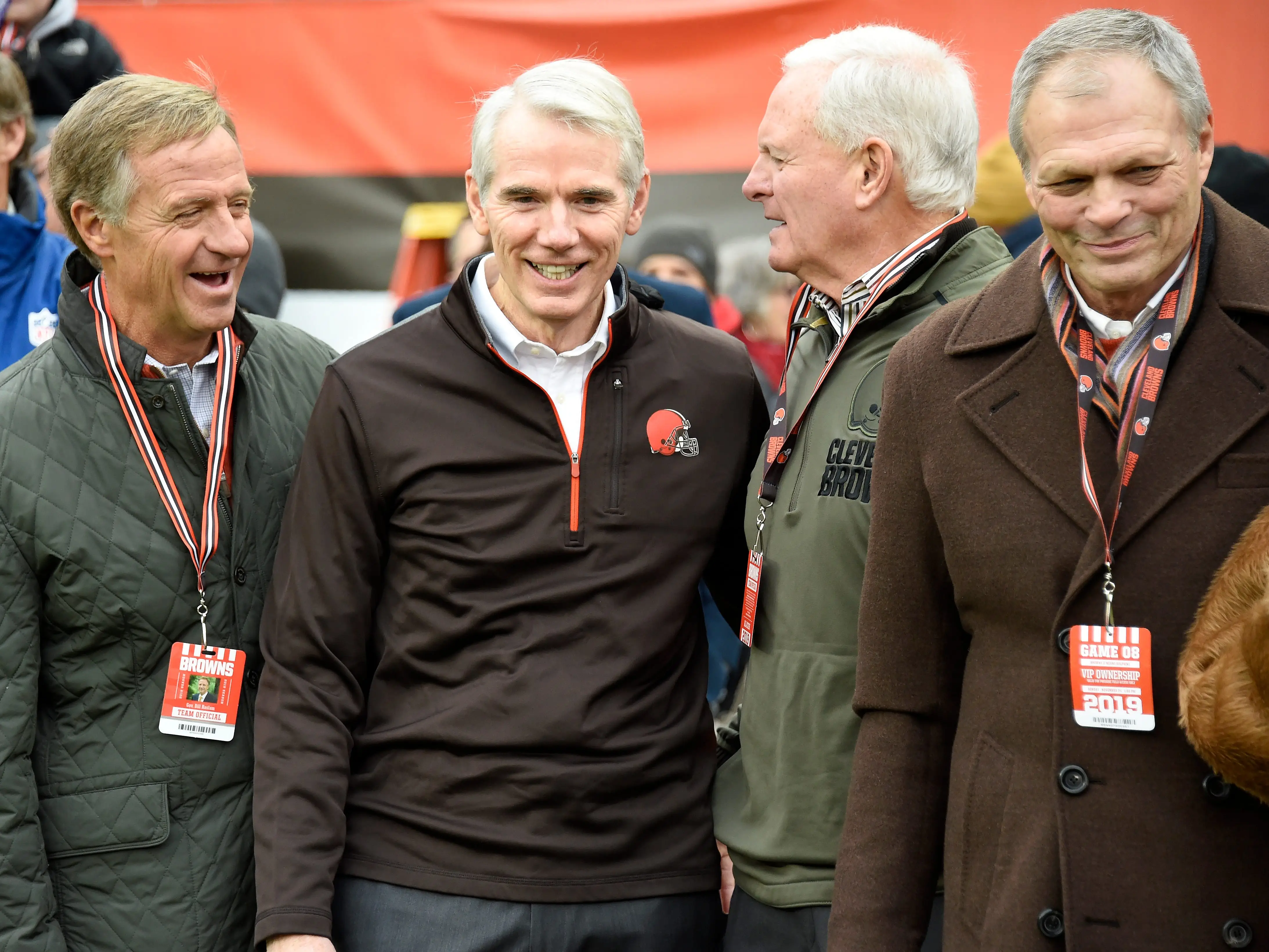 Former Tennessee governor Bill Haslam (L), Ohio Republican Senator Rob Portman (C) and team owner Jimmy Haslam (2R) talk on the sidelines prior to the game against the Miami Dolphins at FirstEnergy Stadium on November 24, 2019 in Cleveland, Ohio