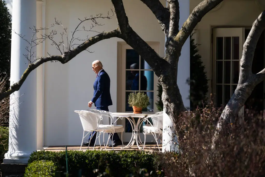 Joe Biden leaves the Oval Office.