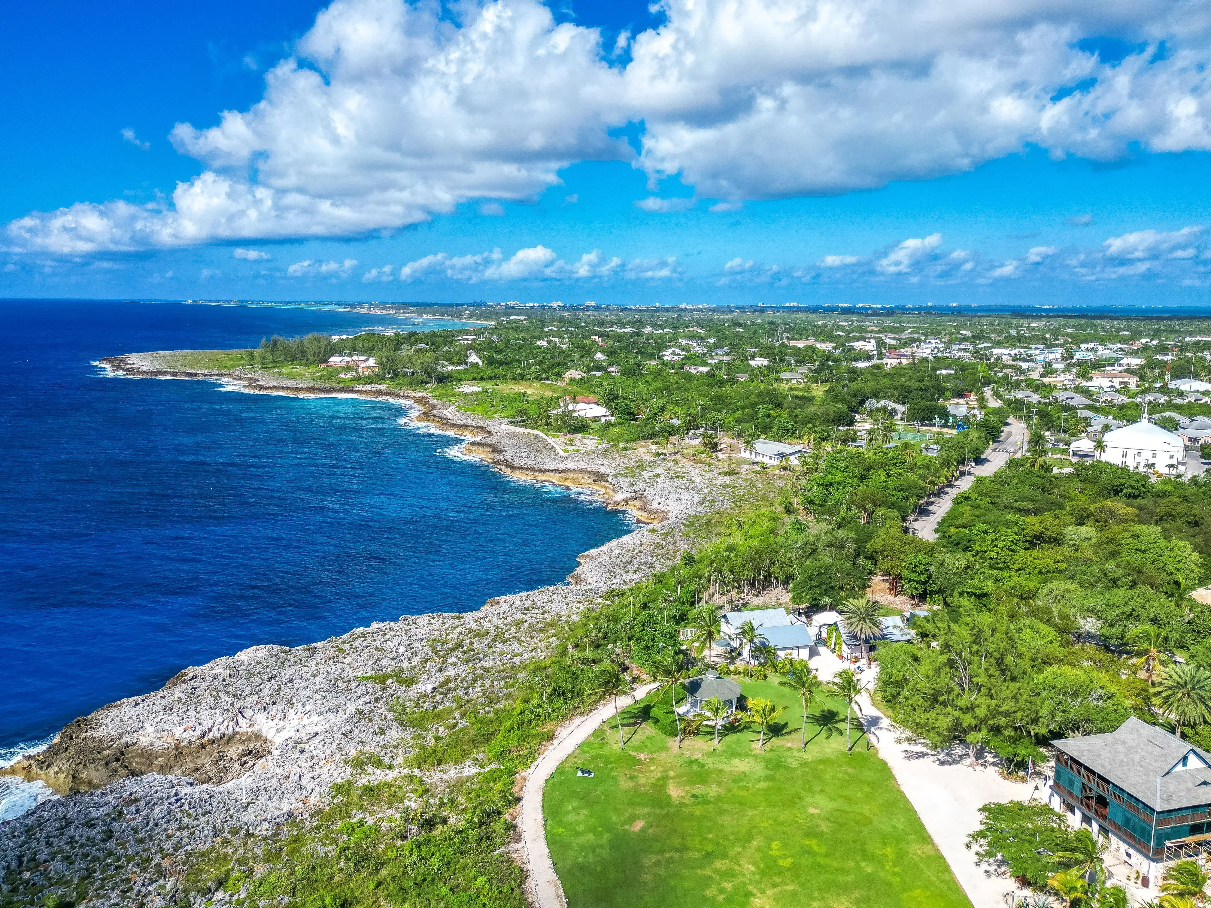 Aerial of historic Pedro St James Bodden Town Savannah Prospect Grand Cayman Cayman Islands with lush greenery trees and buildings beautiful pristine sea ocean turquoise blue water