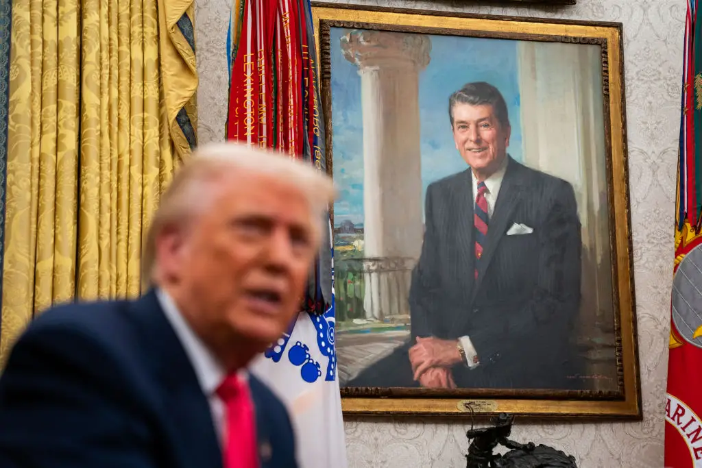 A portrait of Ronald Reagan in Trump's Oval Office.