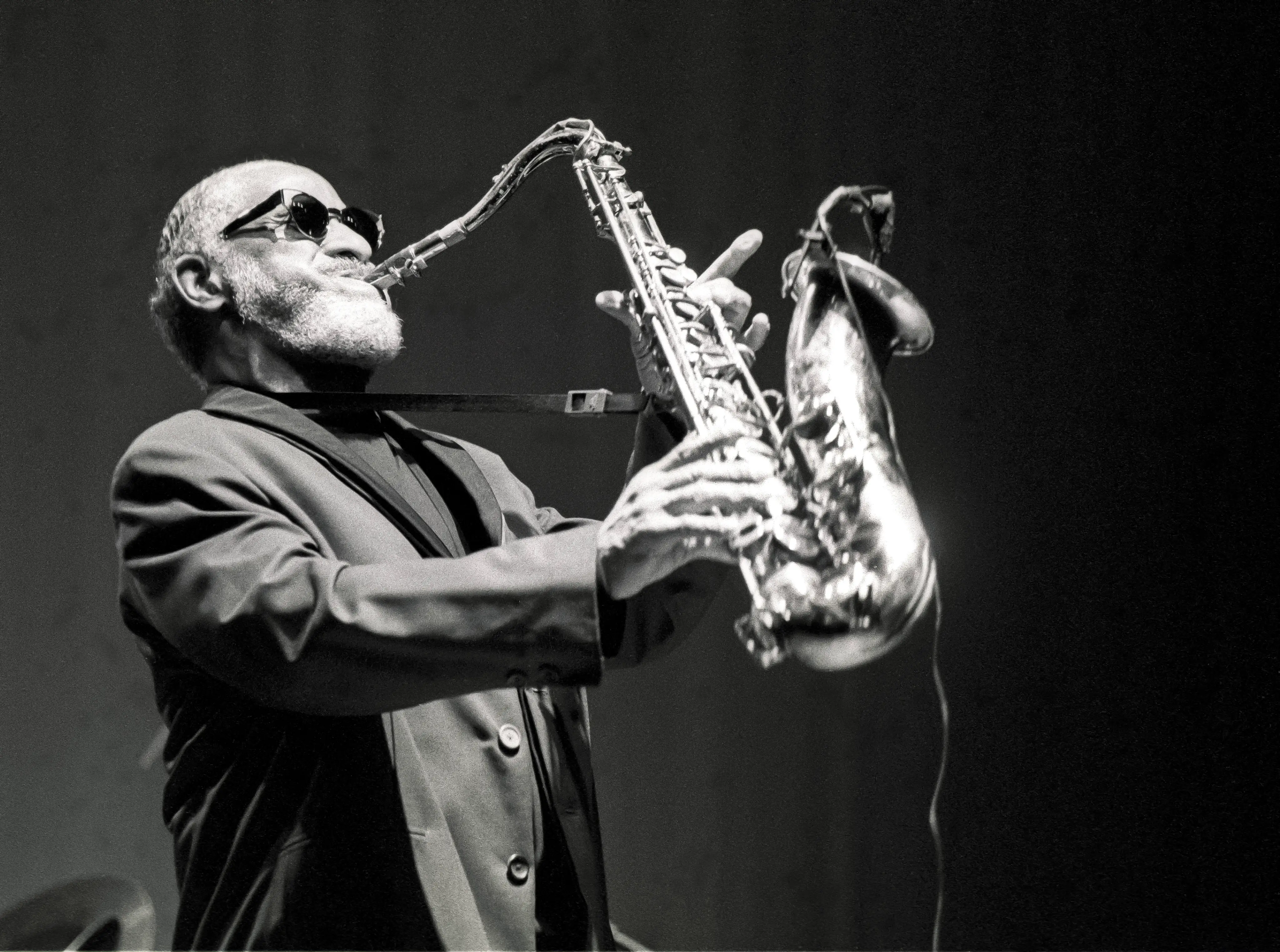Sonny Rollins wearing sunglasses and playing a saxaphone