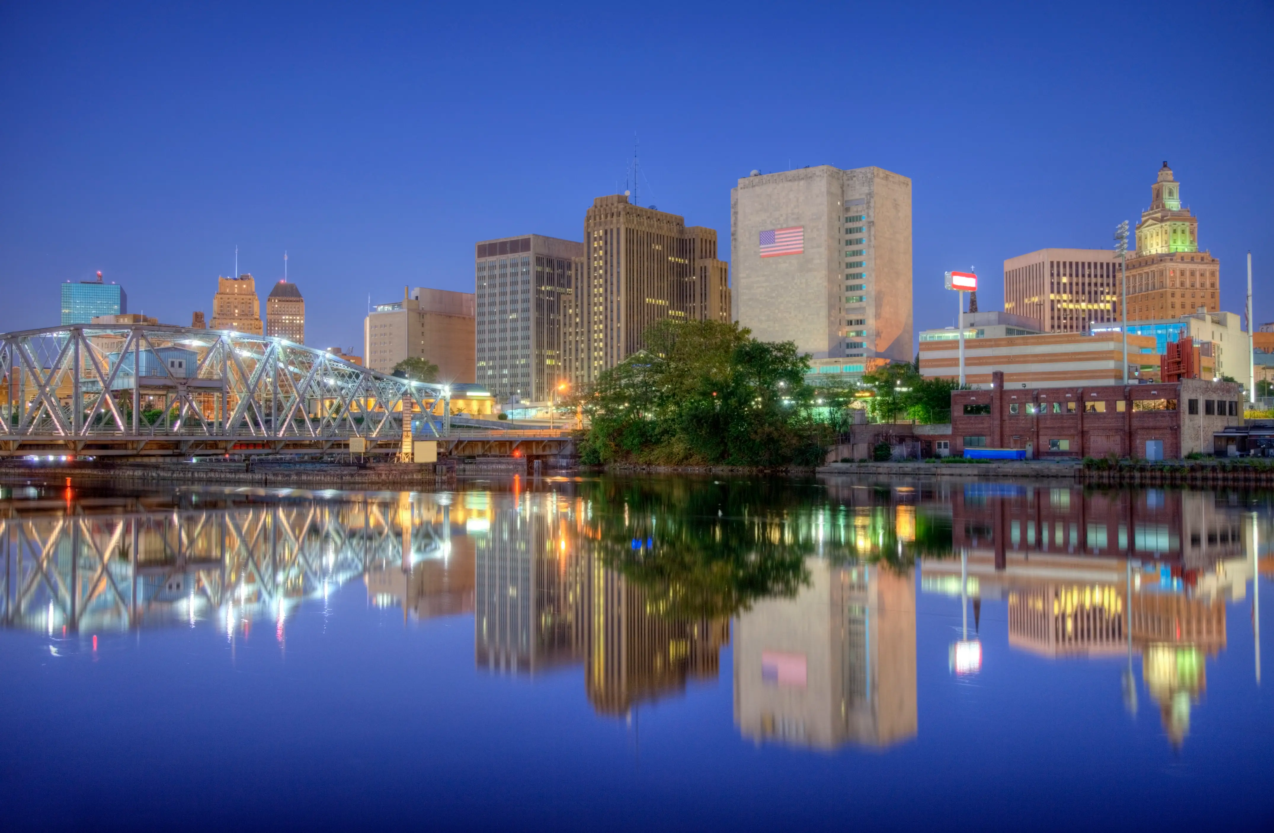 Newark, New Jersey, skyline reflection on the banks of the Passaic River at night.
