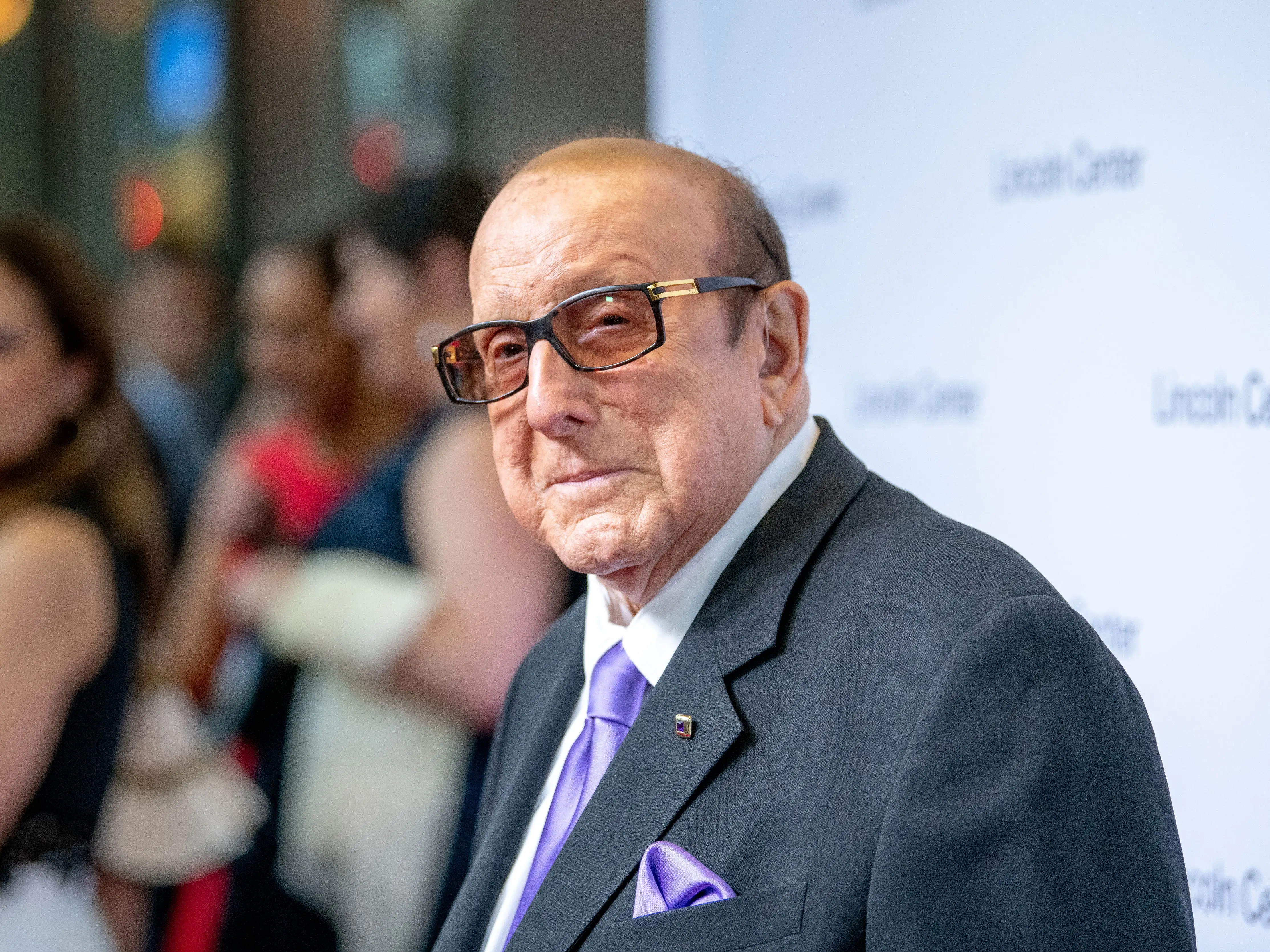 Clive Davis in a dark suit purple tie