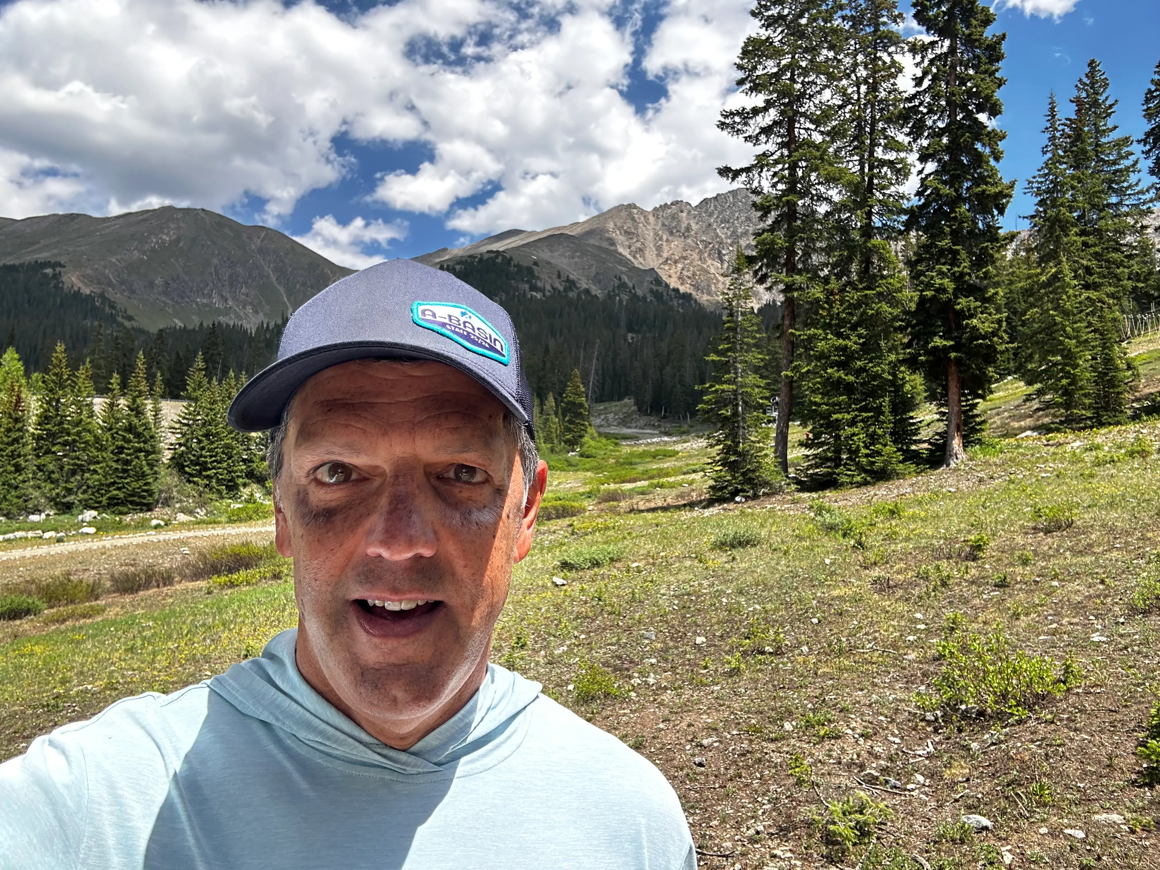 Douglas Craig outside with mountains and trees in the background