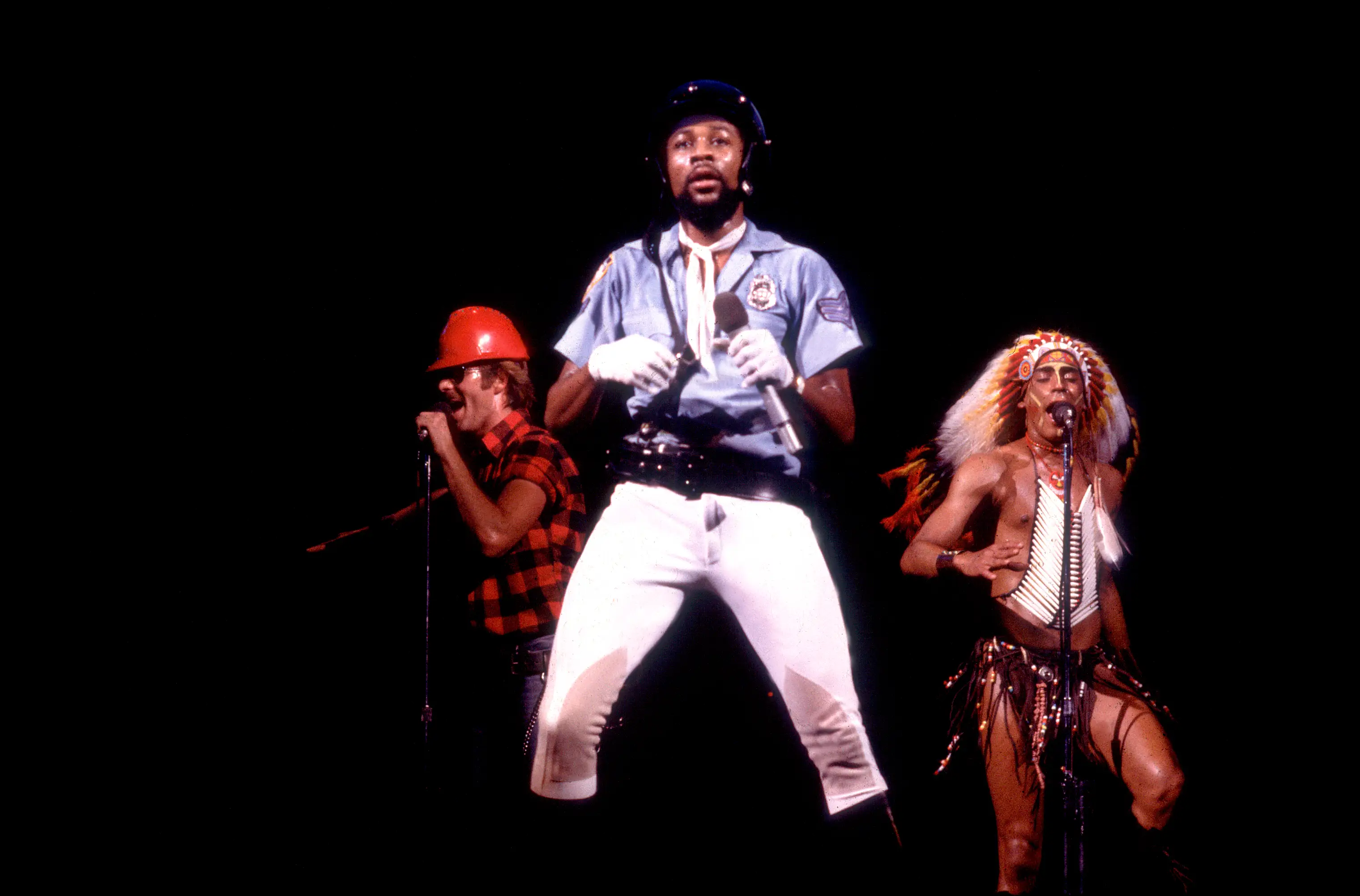 Victor Willis in cop costume on stage with The Village People