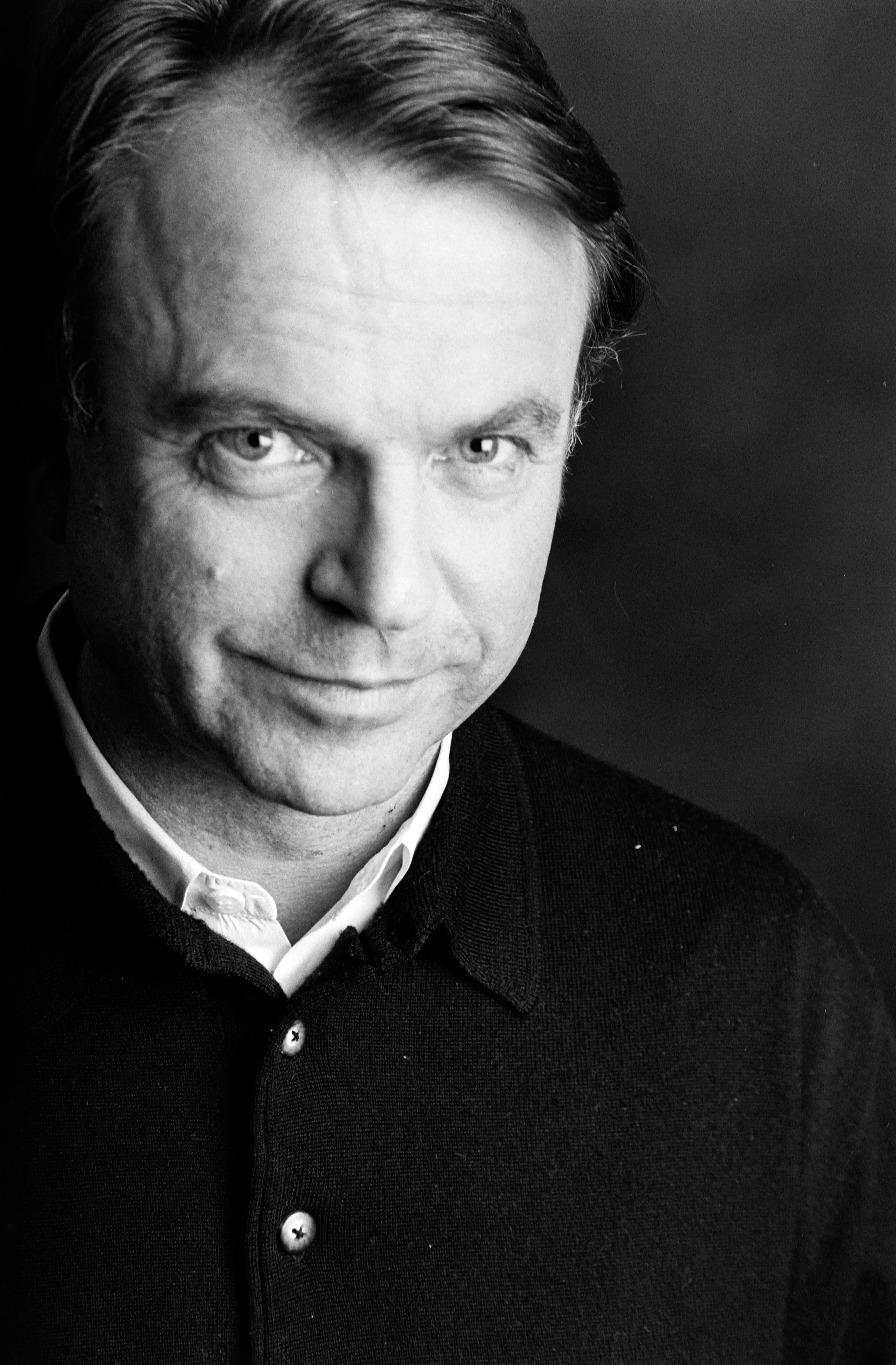 Sam Neill looking into camera black and white