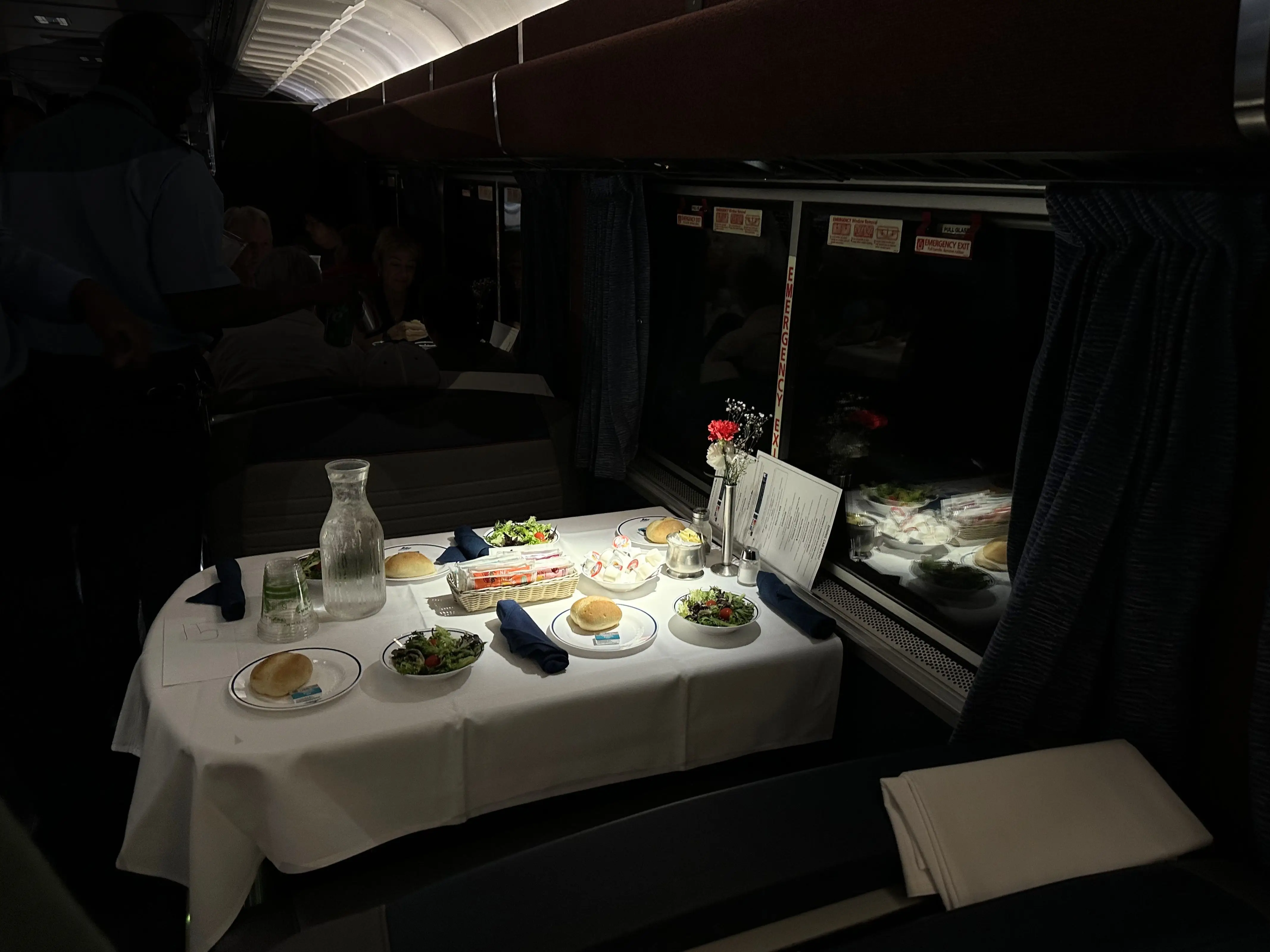 Dimly lit dining car with white table cloth on Amtrak Auto Train