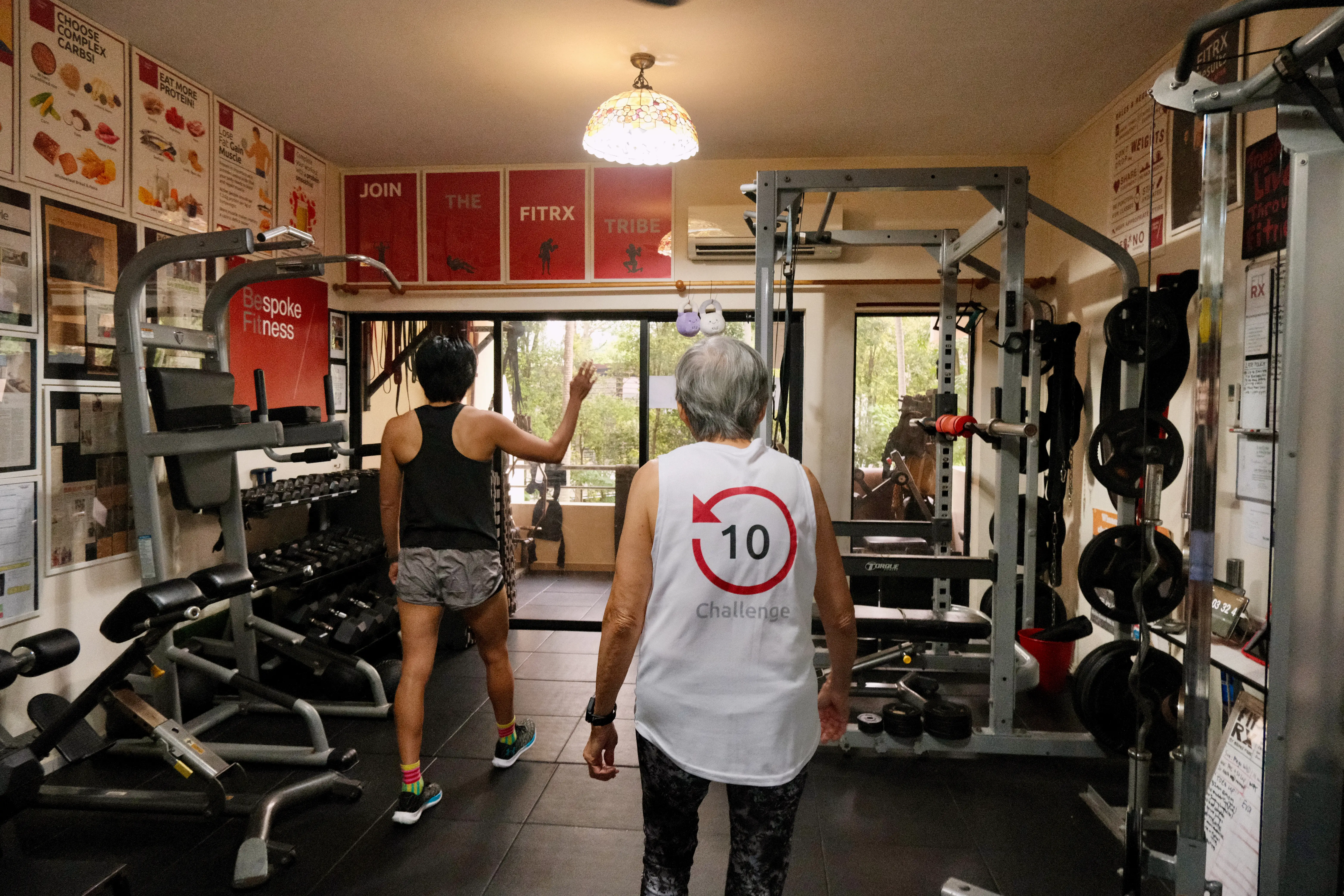 Two women showing me around the home gym.