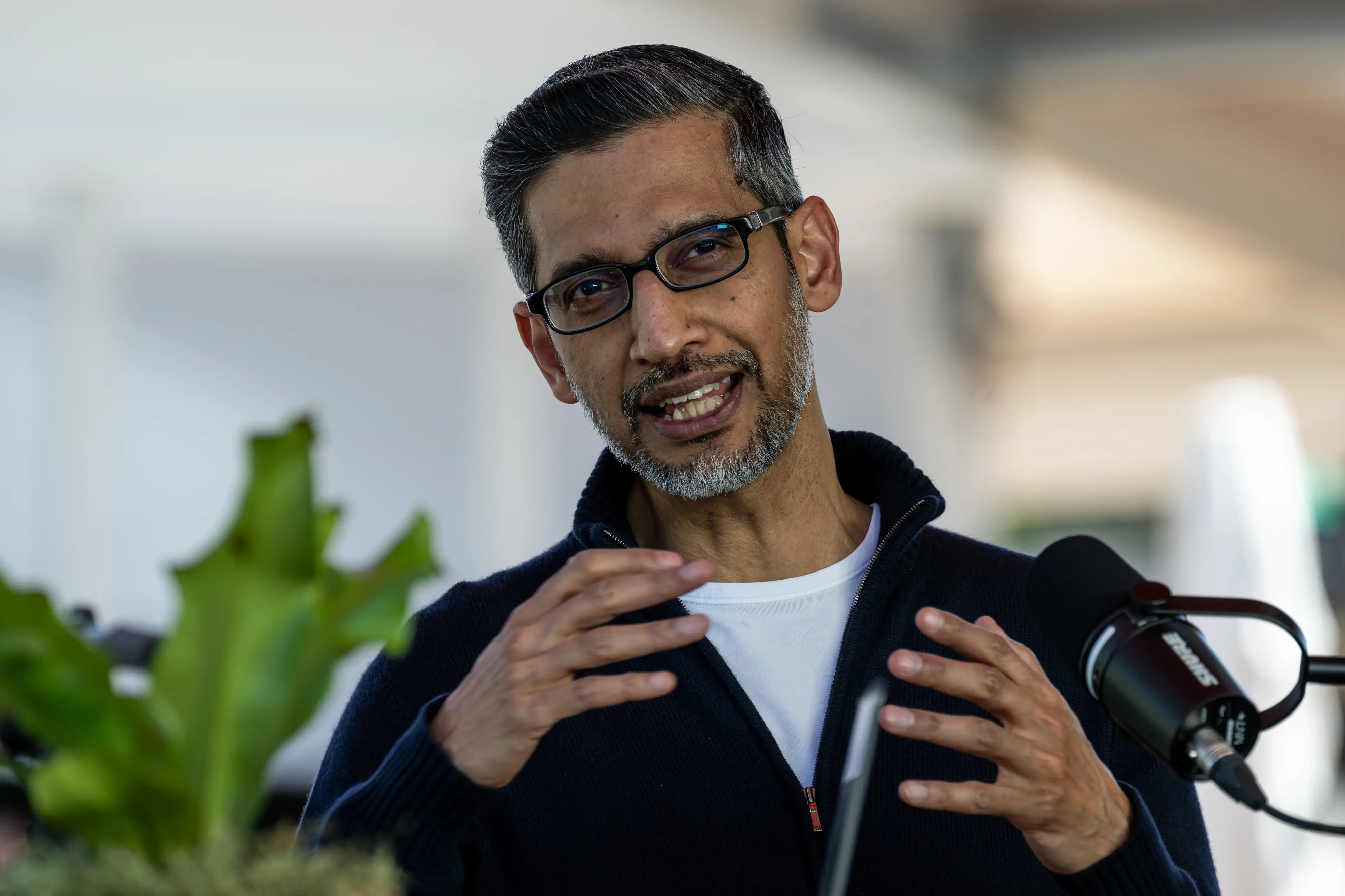 Google CEO Sundar Pichai is raising his hands.