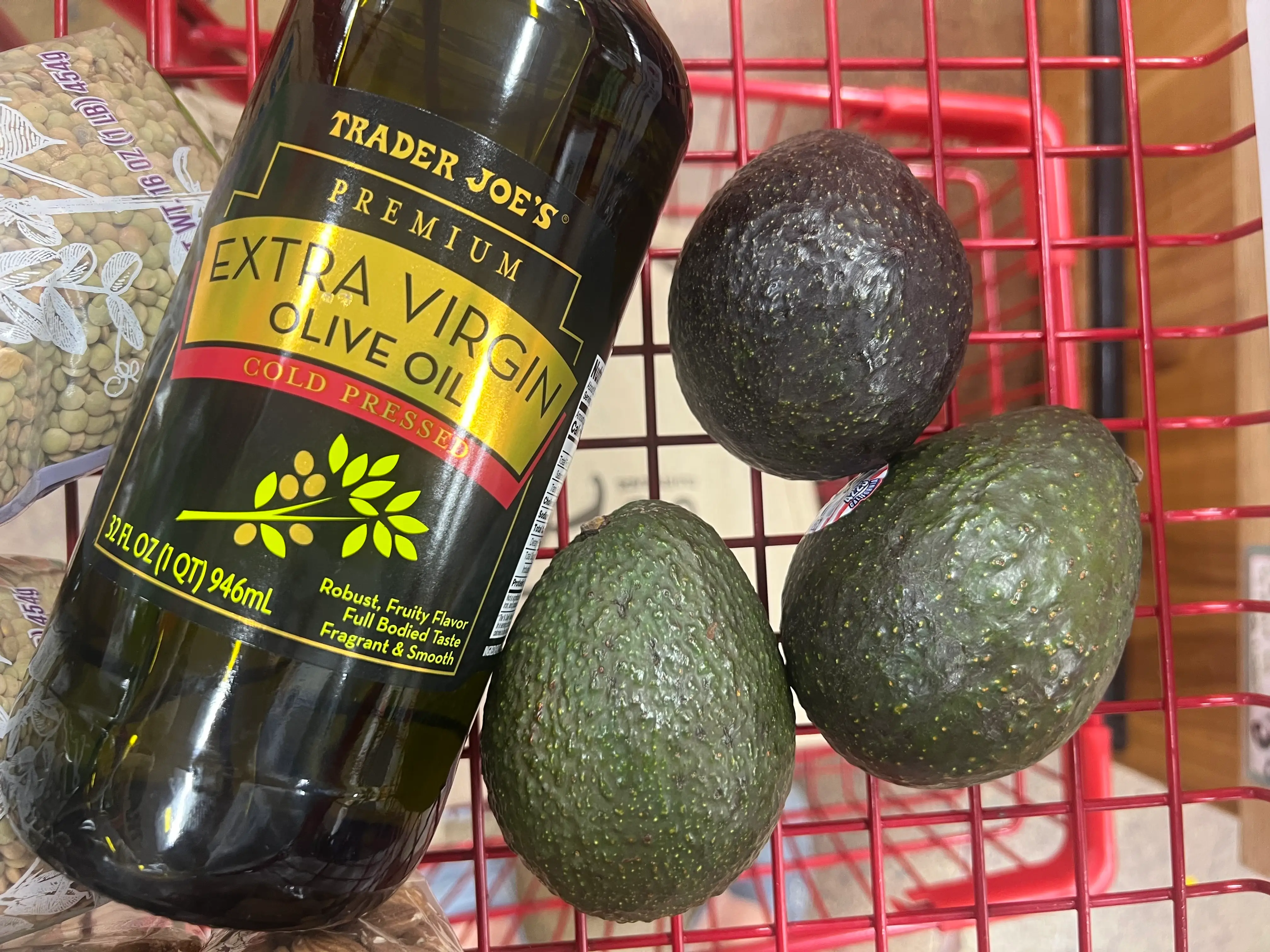 Trader Joe's extra-virgin olive oils in cart with avocados