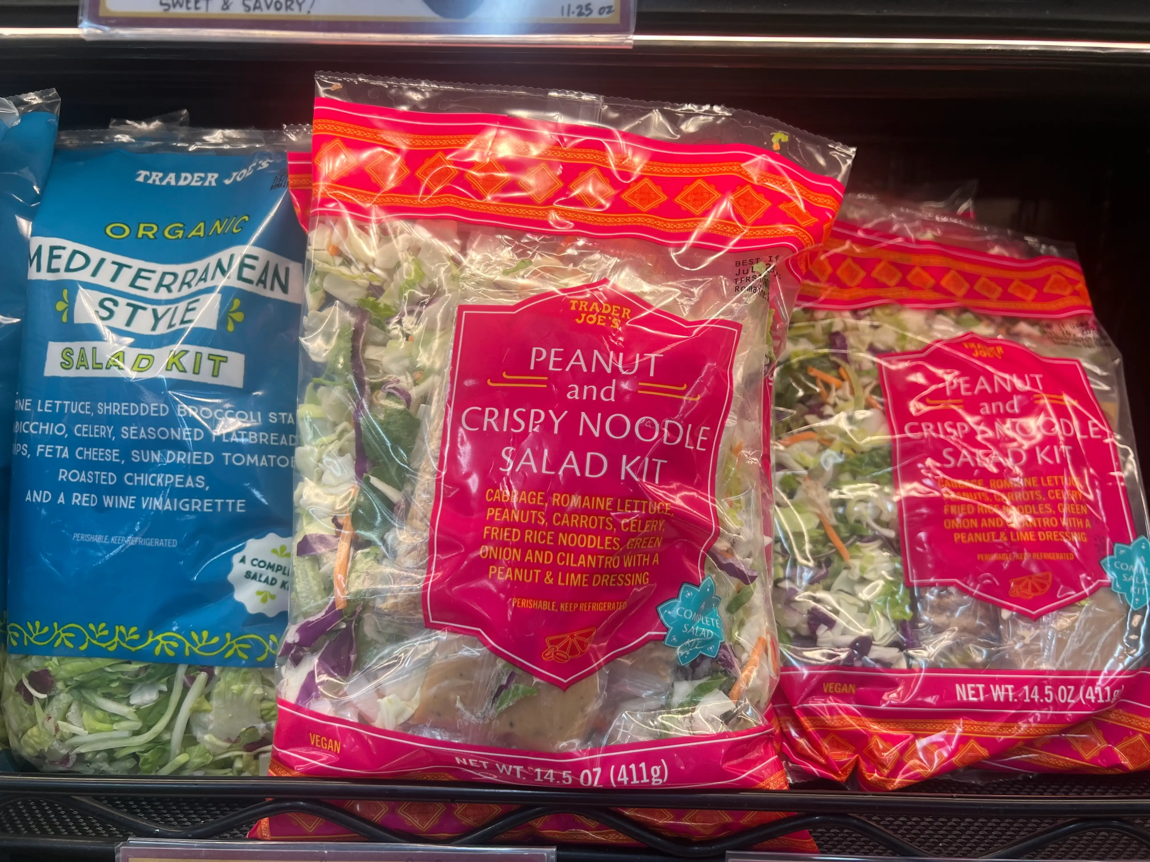Bagged salads on shelf at Trader Joe's