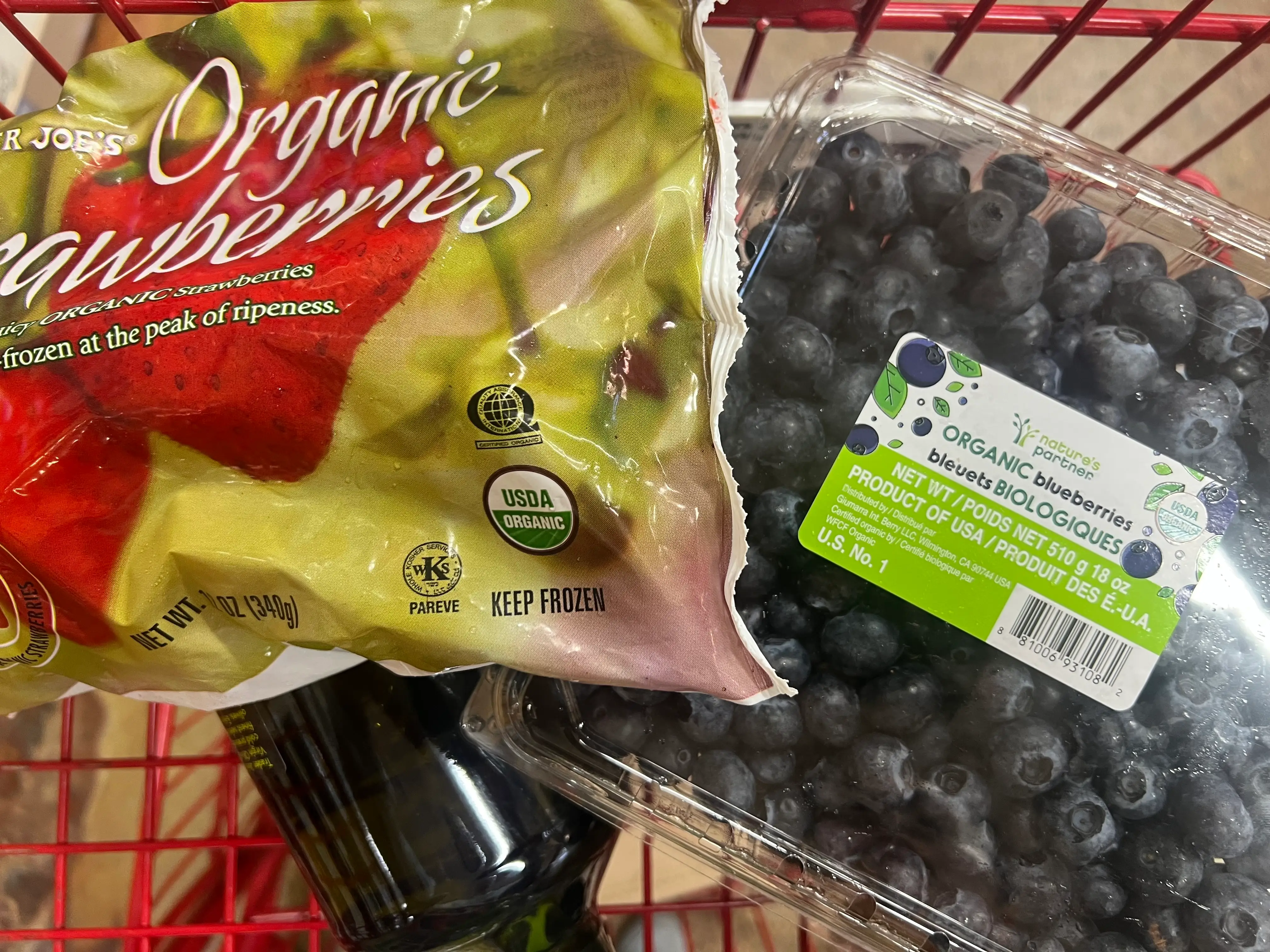Trader Joe's frozen strawberries and container of blueberries