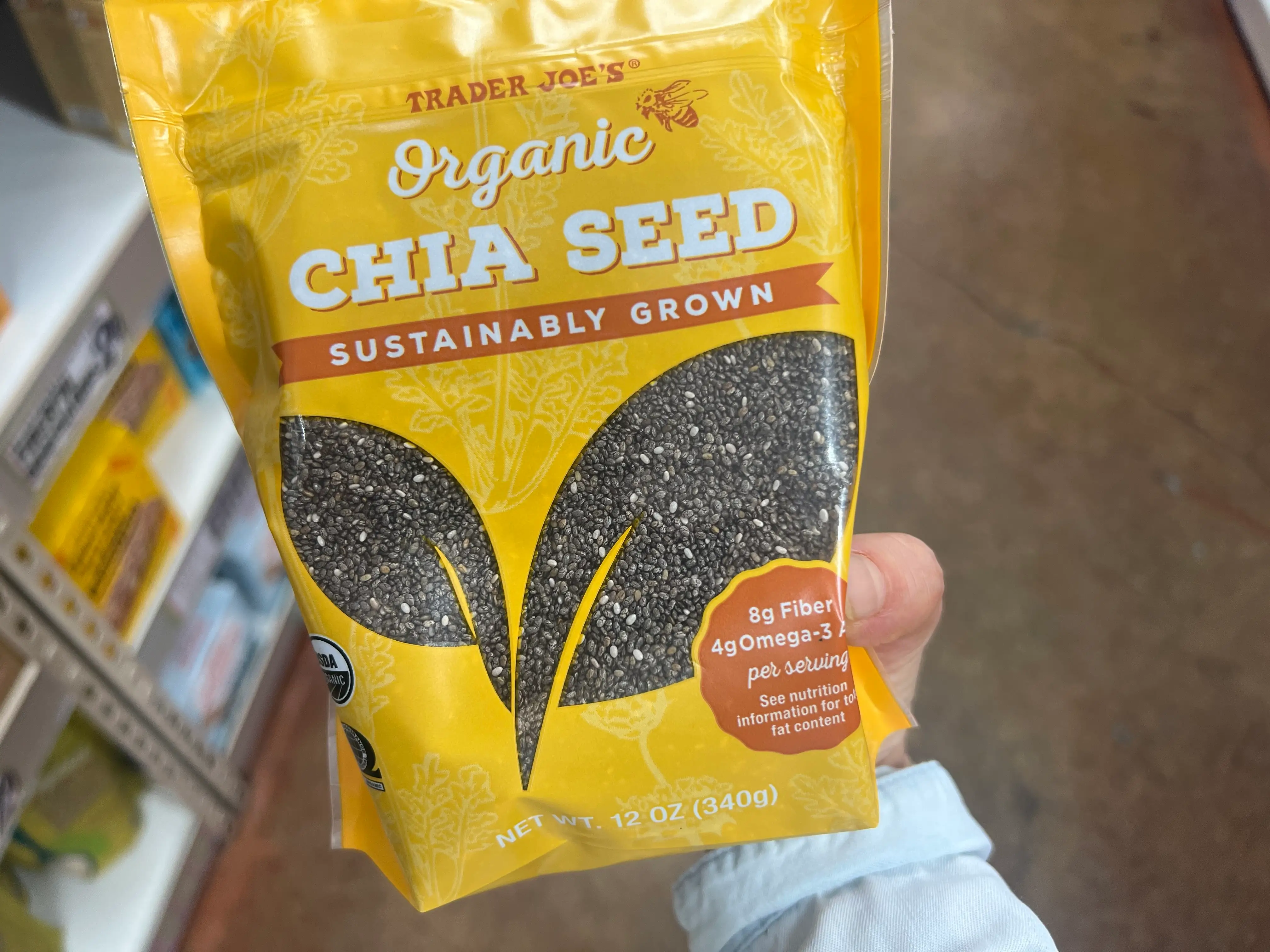 Hand holding Trader Joe's organic chia seeds