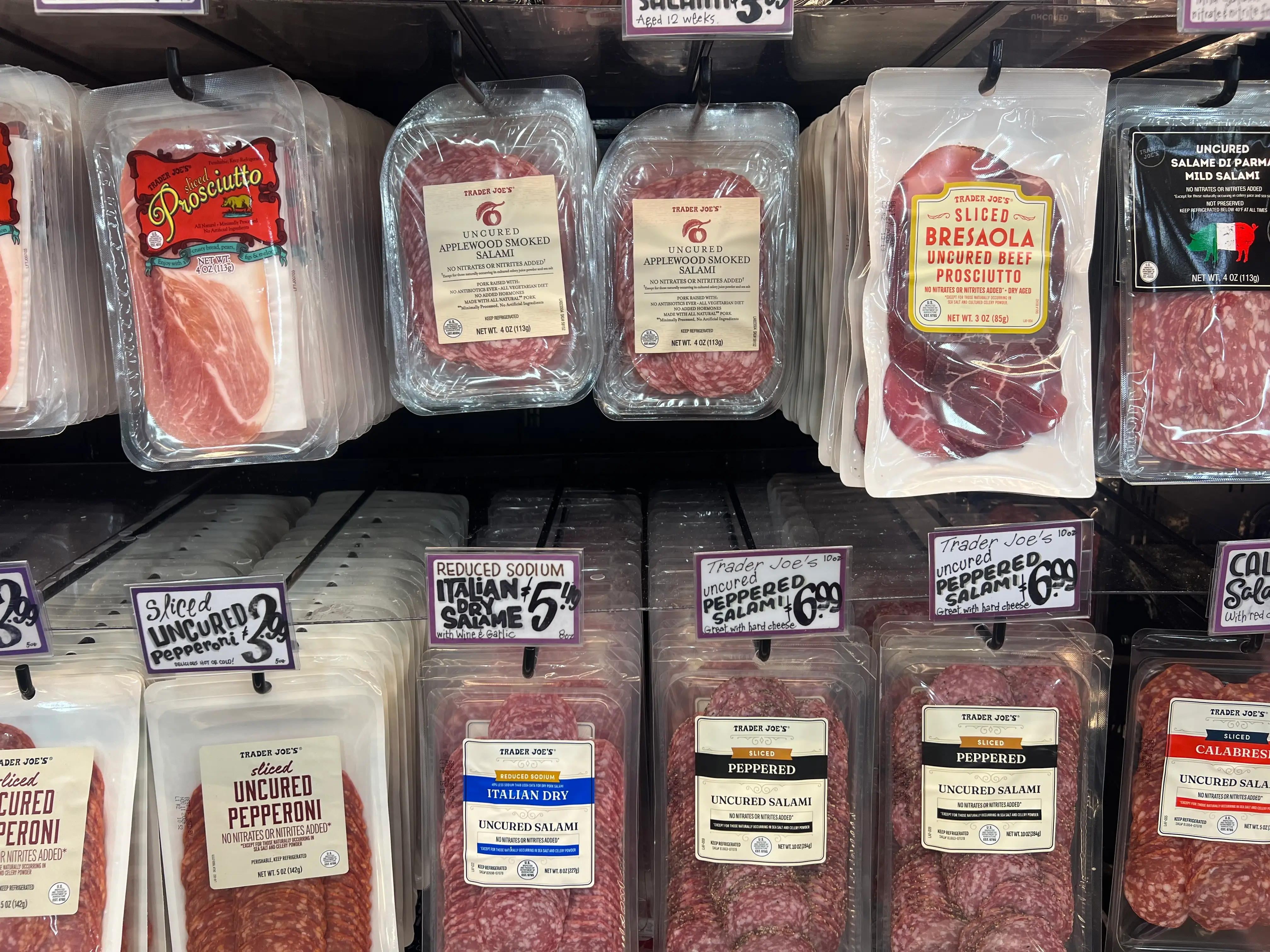 cured and processed meats on display at a Trader Joe's