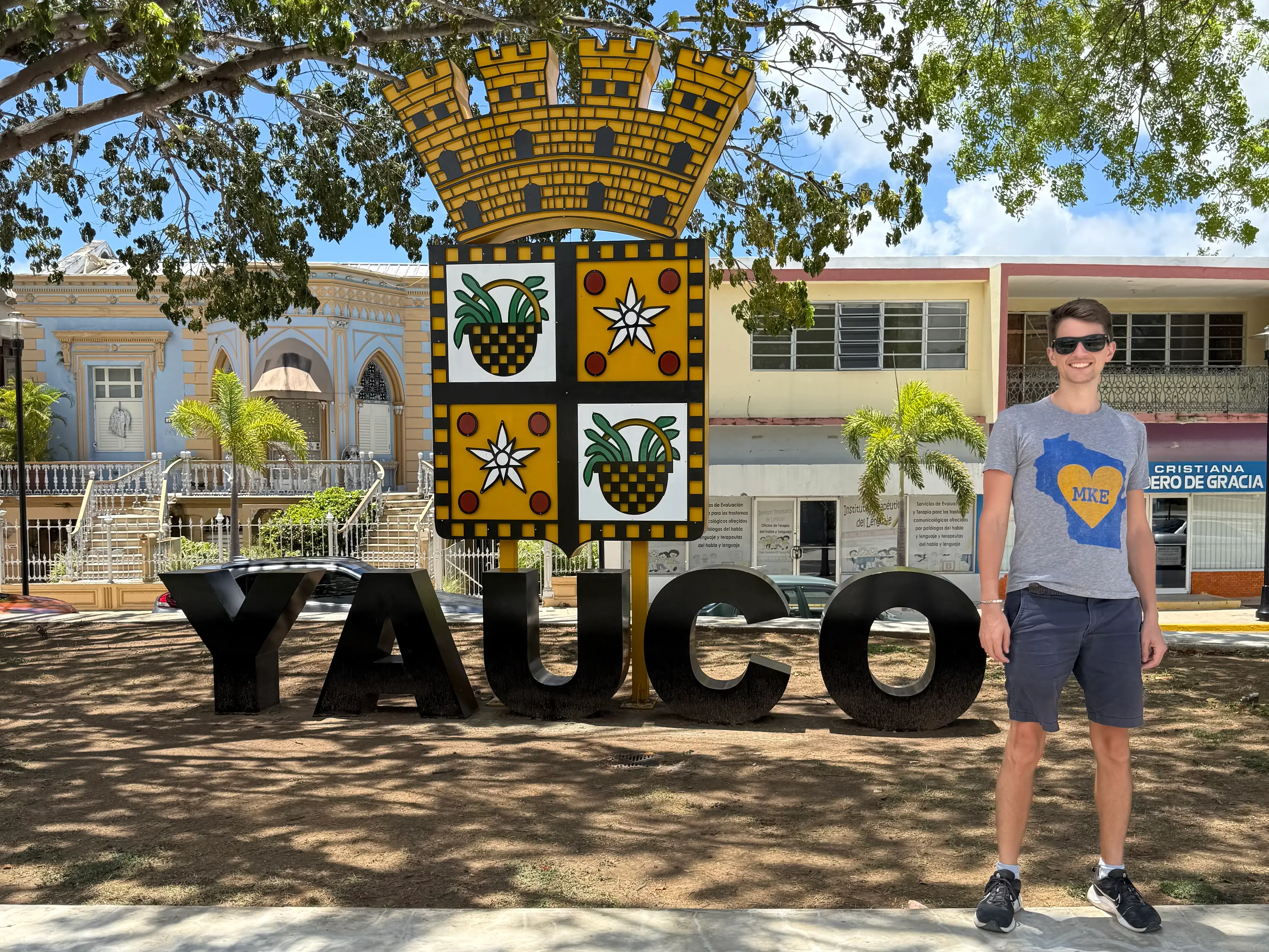 Man standing in front of Yauco sign