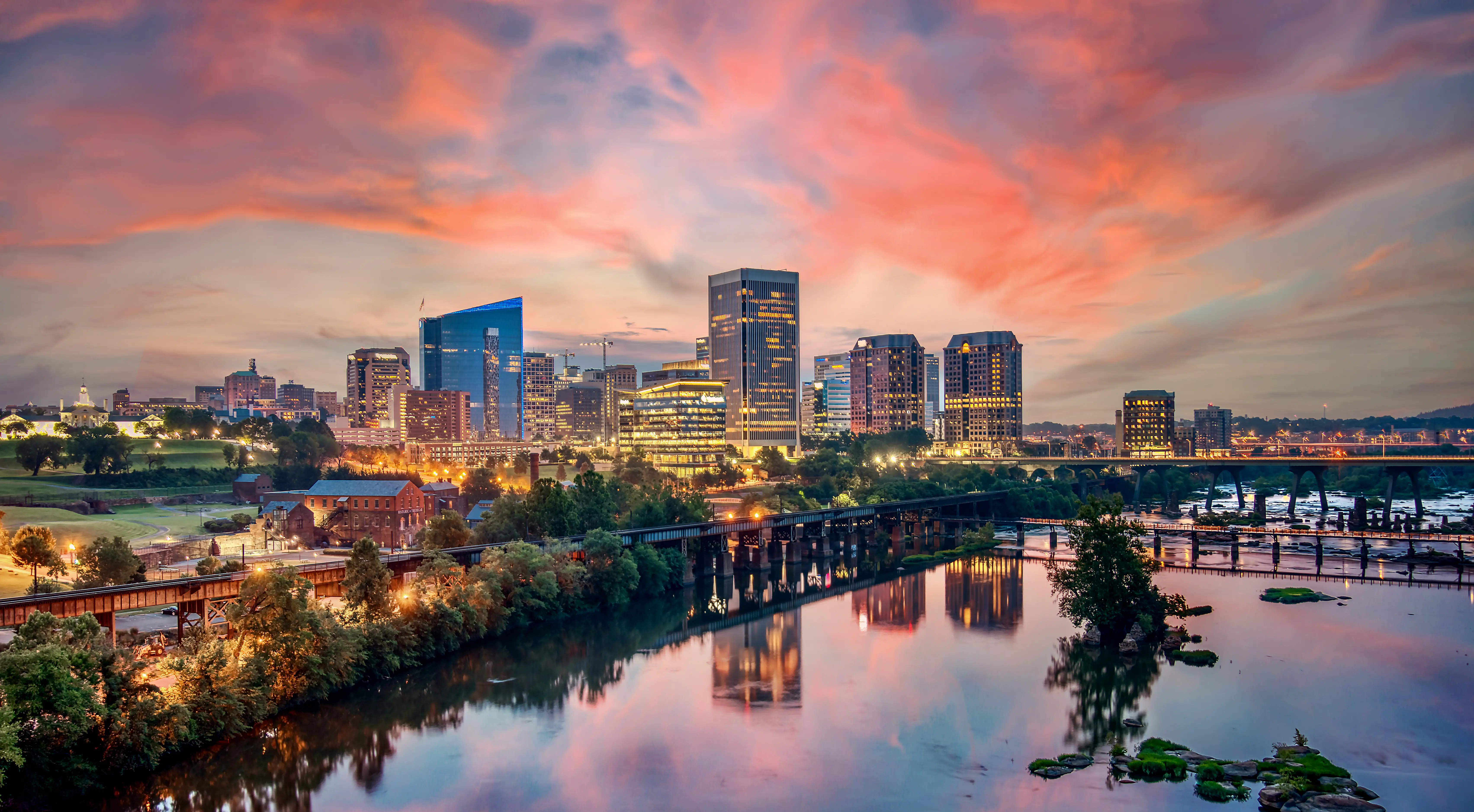 A colorful sunrise over the city of Richmond, Virginia skyline and the James River.