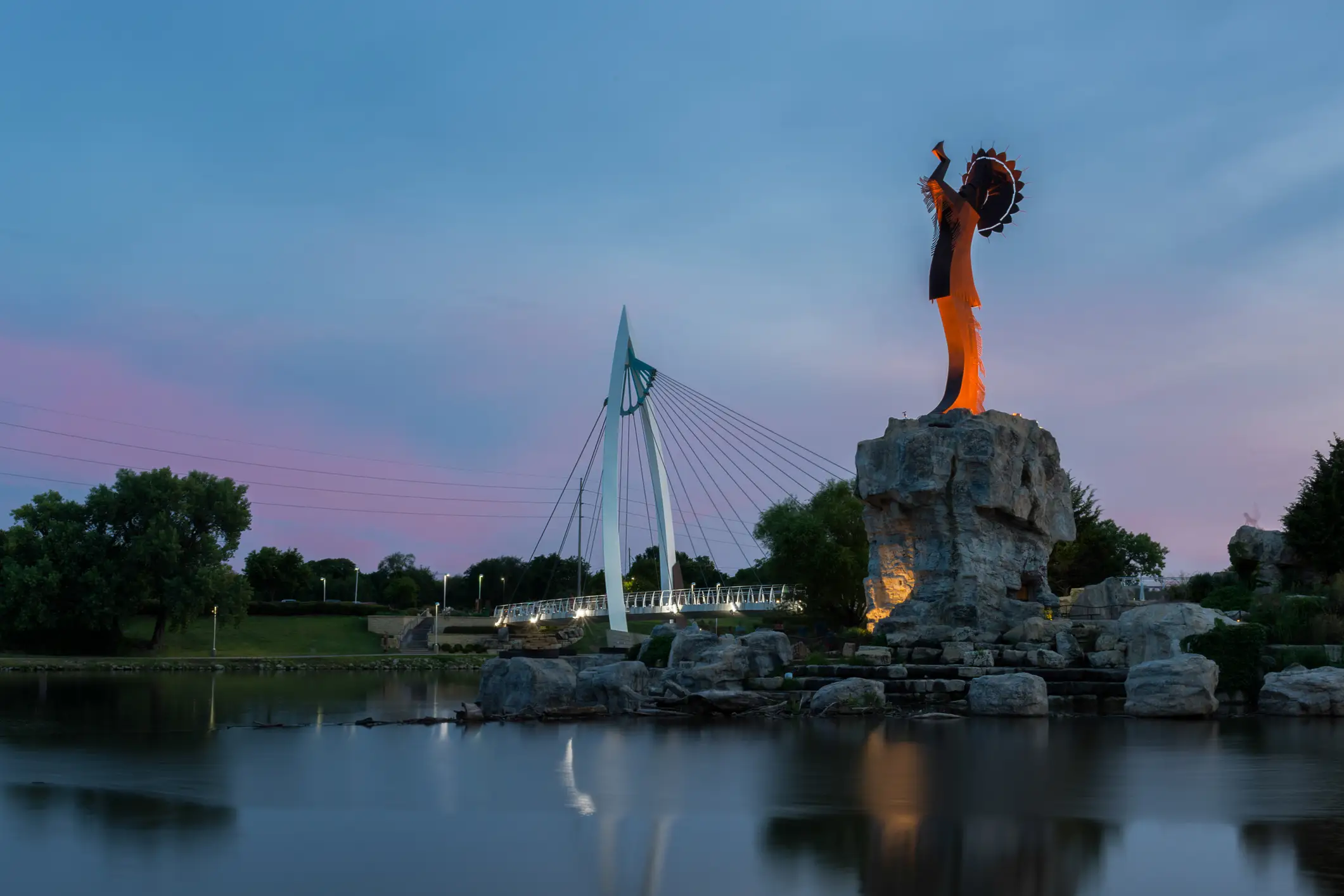 Keeper of the Plains steel sculpture on the Arkansas River at dusk