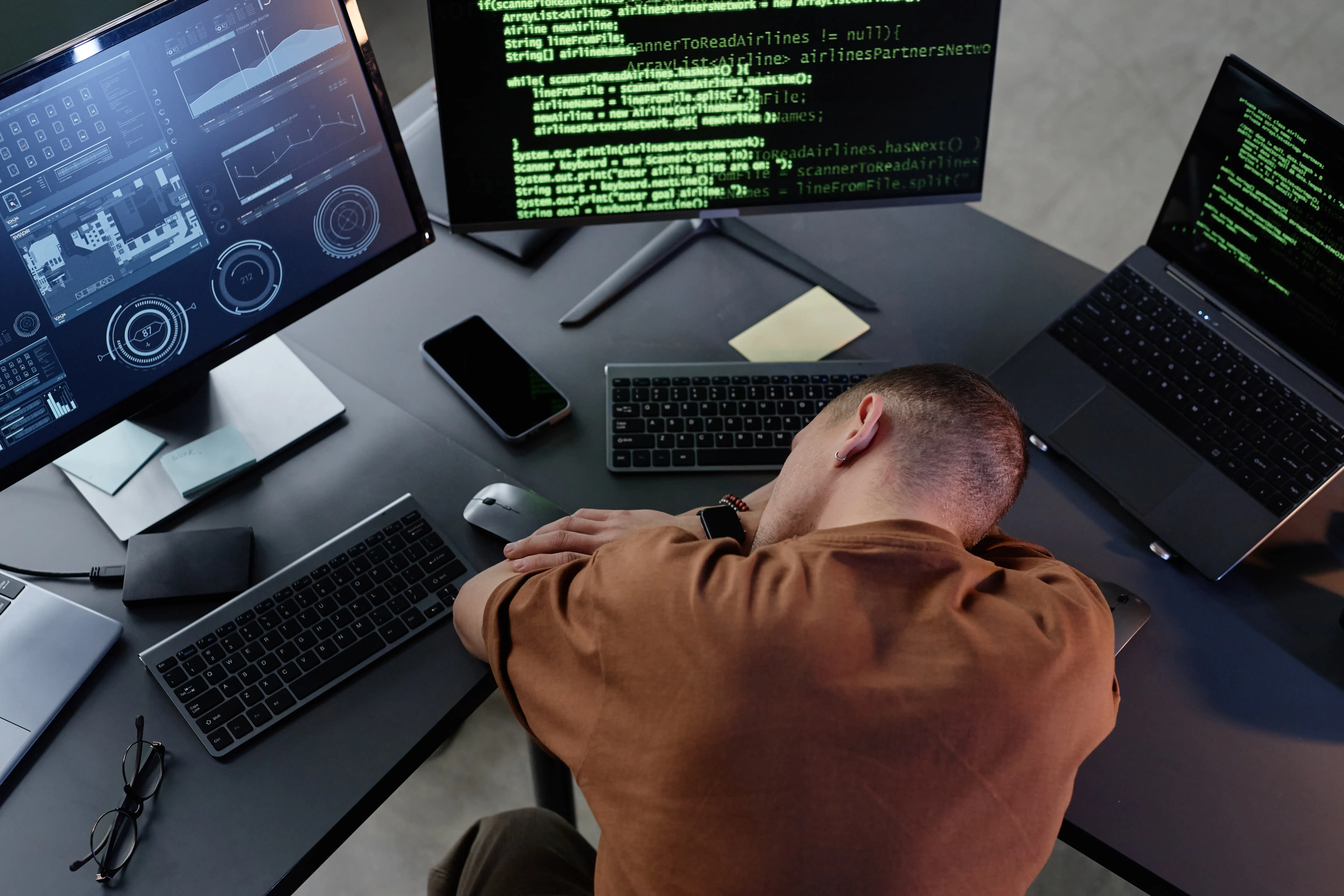 A man burnt out resting head on desk