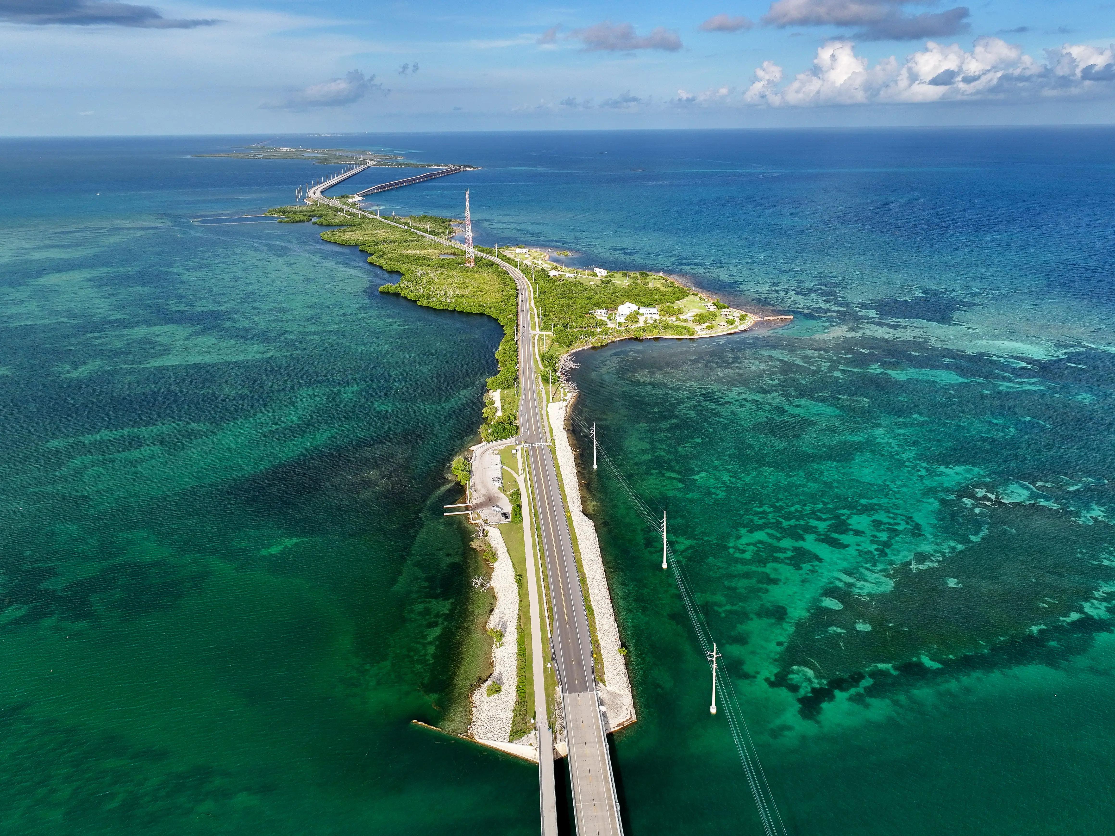 An aerial view of the Overseas Highway, which is surrounded by turquoise water.