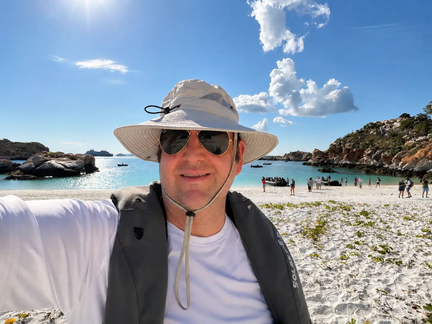 Man in hat smiling on beach