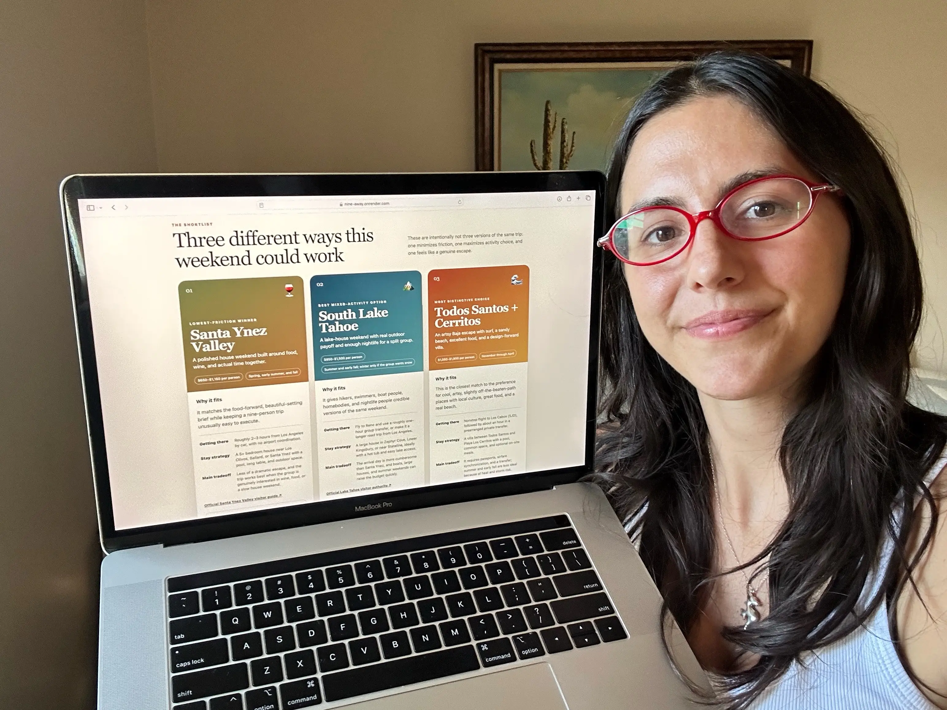 The author taking a selfie with her laptop featuring the website she built.