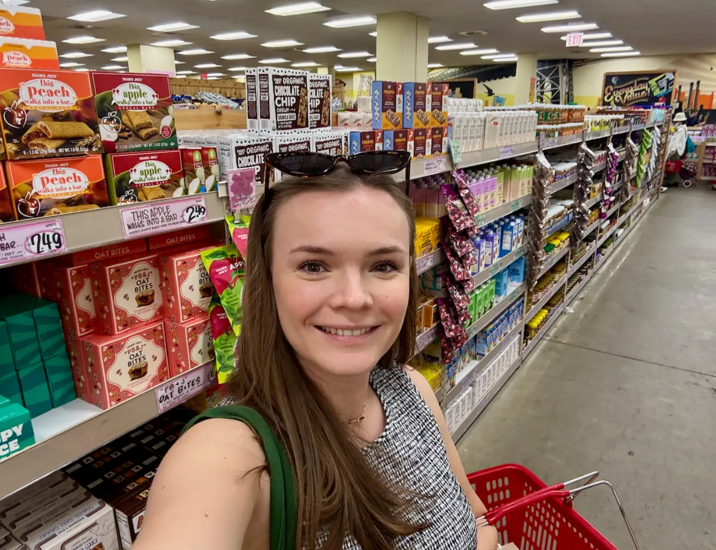the writer posing in an aisle at Trader Joe's.