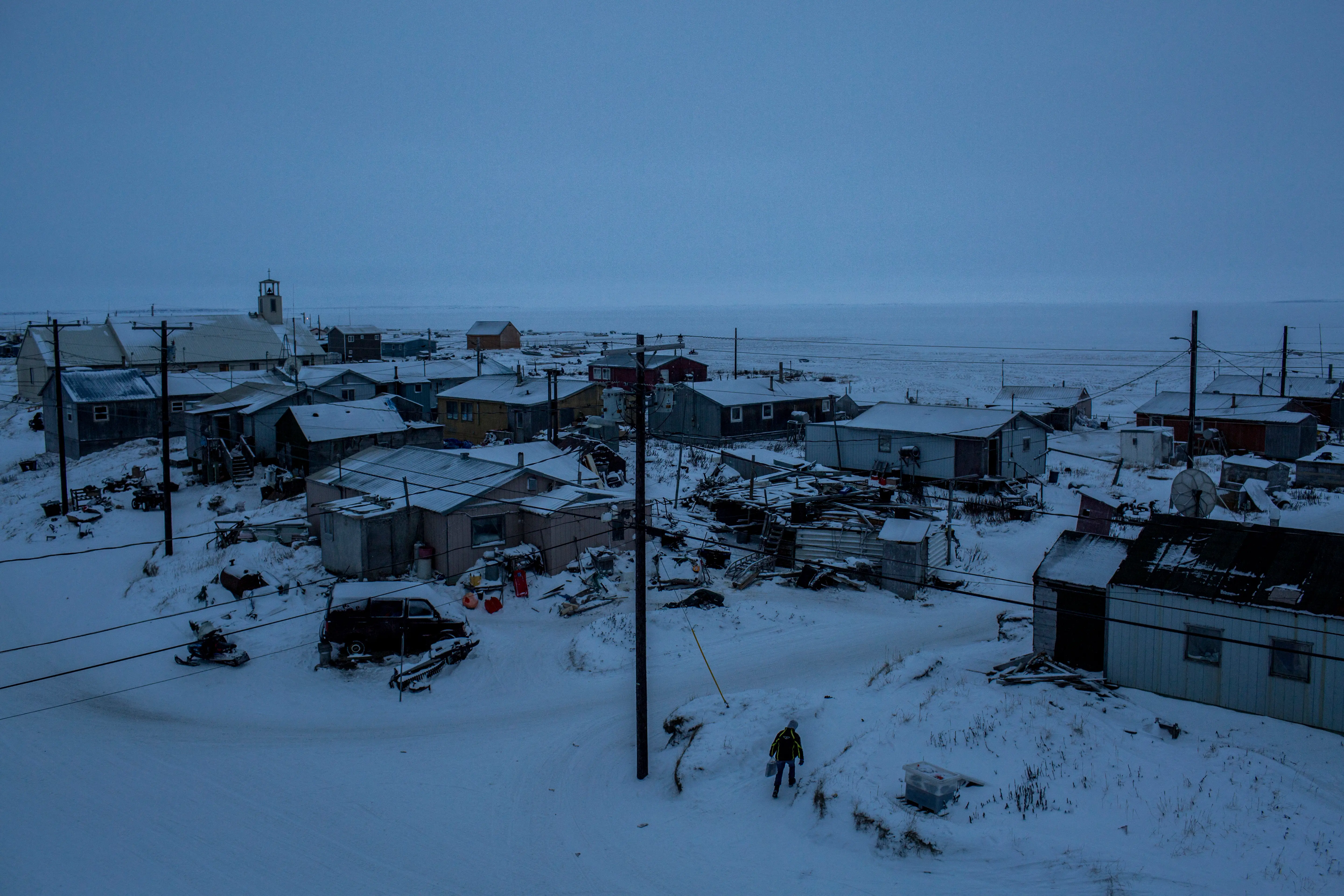 Shishmaref, a barrier island with a population of less than 600 Alaska native Inupiaq people covered in snow in harsh Arctic environment.