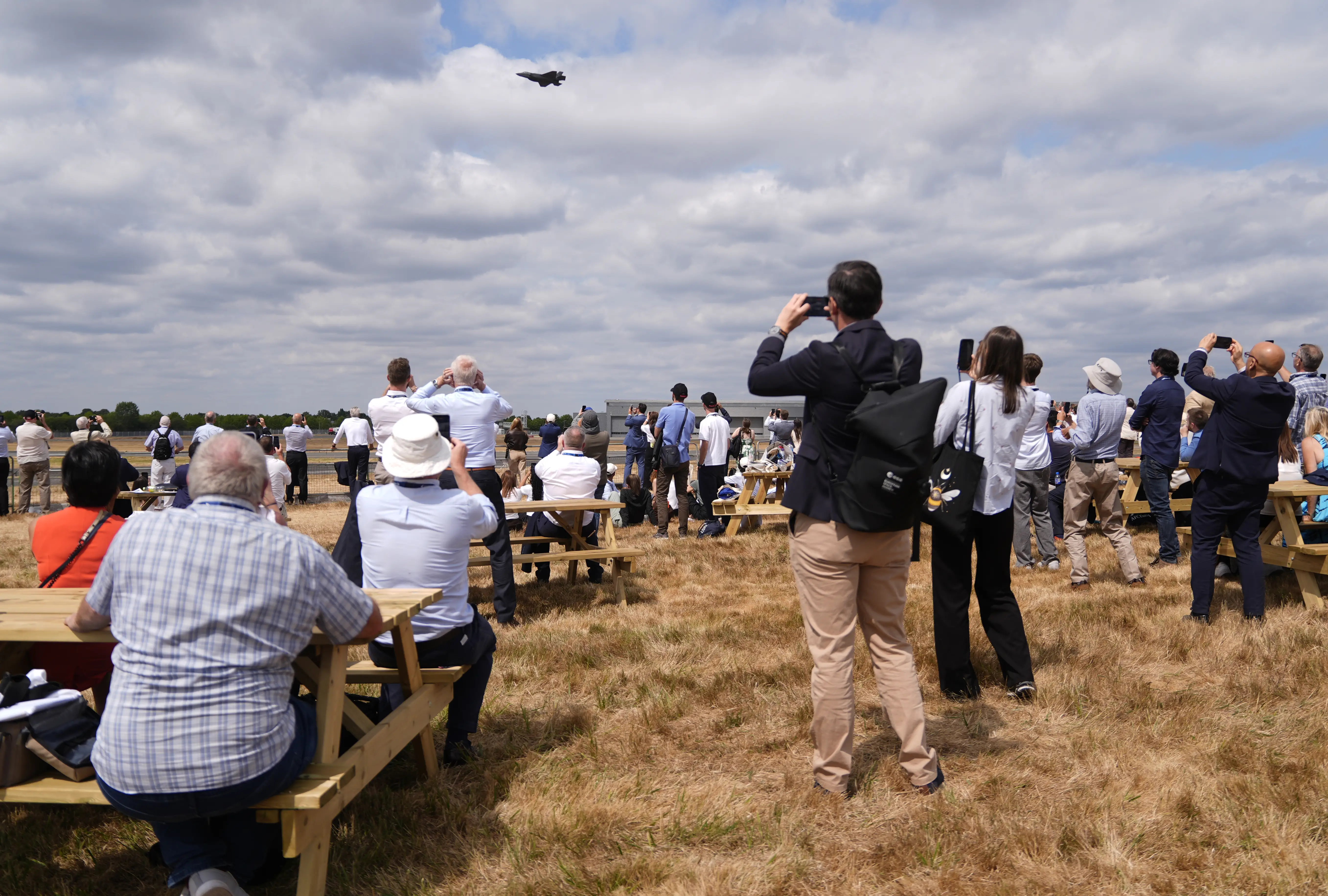 People watch a USAF F-35A Lightning II display at the Farnborough International Airshow in Hampshire. Picture date: Tuesday July 21, 2026.