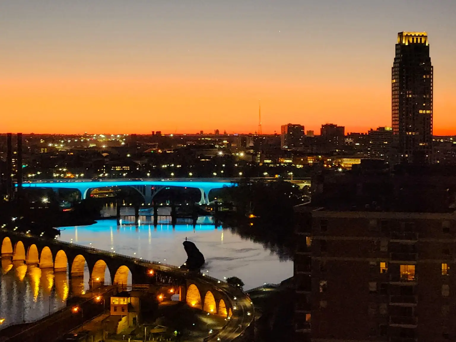 View of Minneapolis city skyline from above at sunset