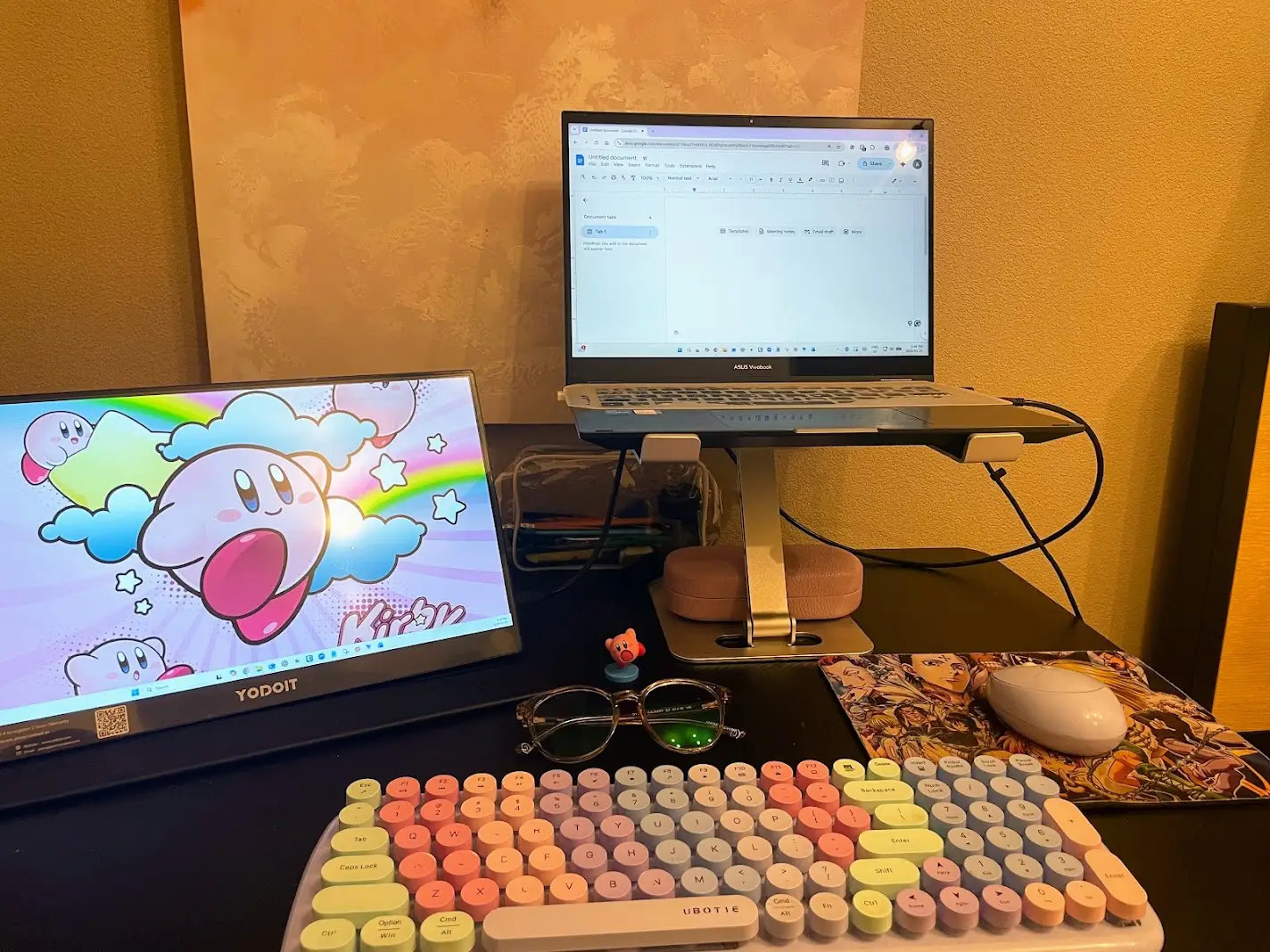 Two laptops, keyboard set up on desk