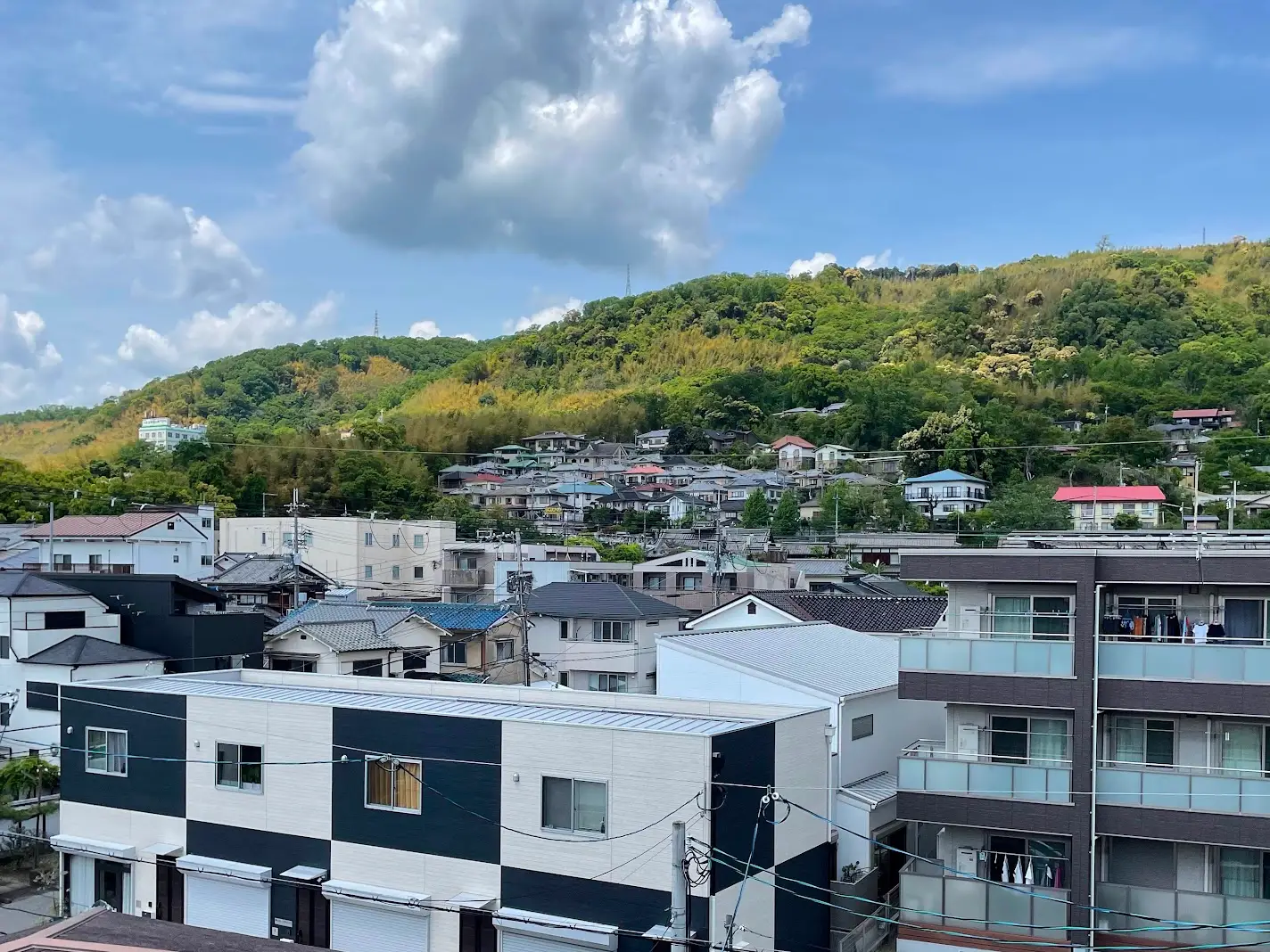 Aerial view of buildings, hills in Japan